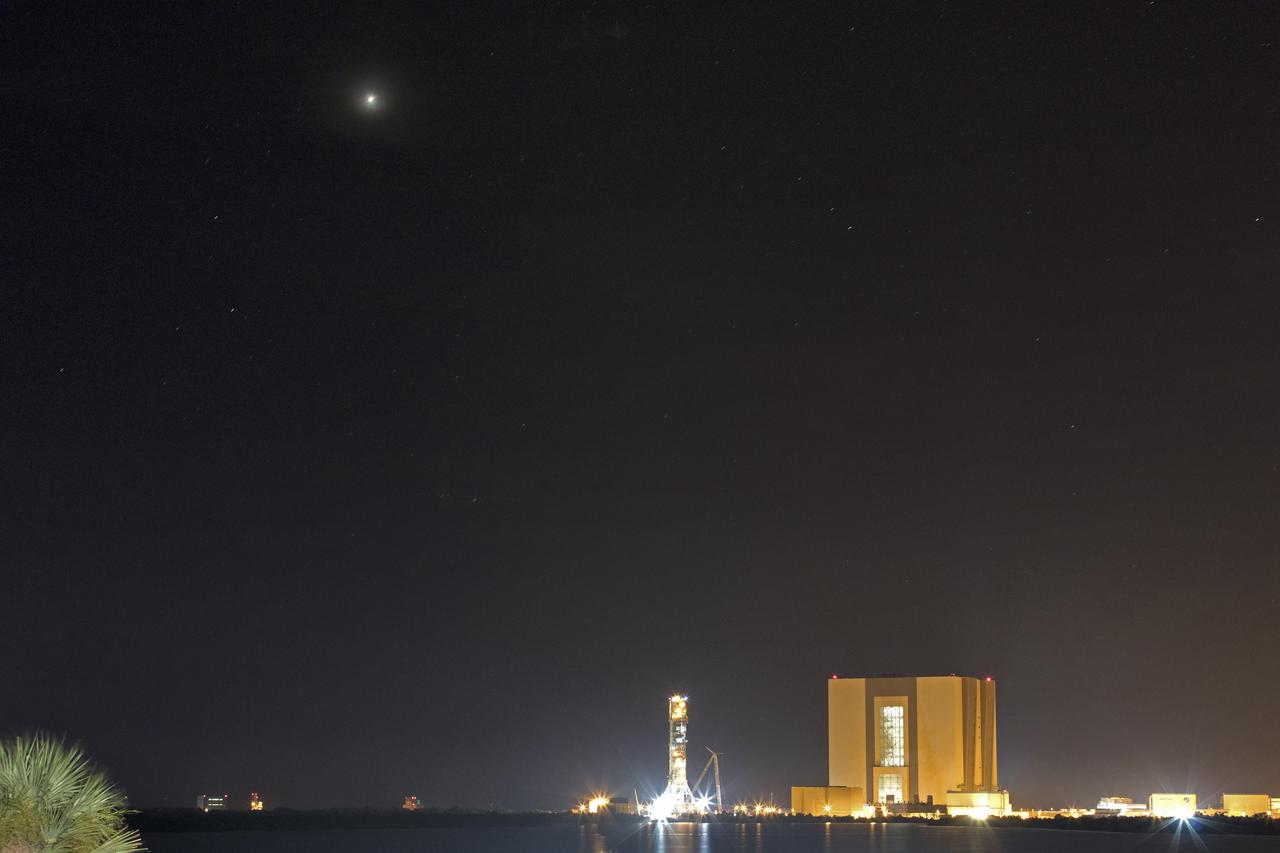 Mars is visible above the horizon in the night sky above Kennedy Space Center in Florida on Monday, July 30, 2018. The Red Planet appeared the brightest from July 27 to July 30, making its closest approach to Earth on July 31. The next Mars close approach is Oct. 6, 2020. A close approach is when Mars and Earth come nearest to each other in their orbits around the Sun.