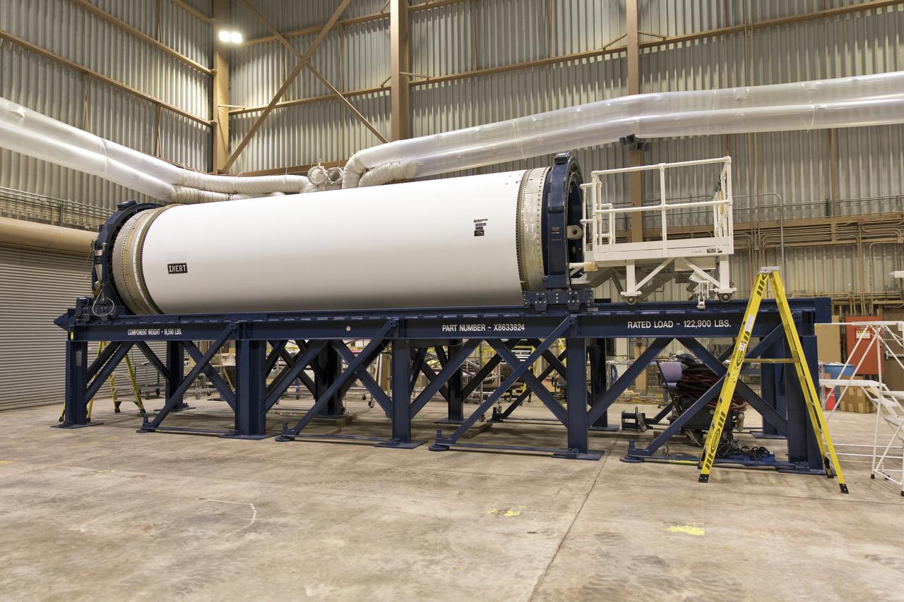 The ground test motor for Orion's Launch Abort System (LAS) is secured on a work stand inside the Rotation, Processing and Surge Facility on July 31, 2018, at NASA's Kennedy Space Center in Florida. It will be inspected and prepared for transport to Space Launch Complex 46 (SLC-46) at Cape Canaveral Air Force Station for mechanical fit testing. This inert motor will not be used for flight, but will be used to certify flight hardware assembly in preparation for a full-stress test of the LAS, called Ascent Abort-2 (AA-2) flight test, scheduled for April 2019. During the test, the booster will launch from SLC 46, carrying a fully functional LAS and a 22,000-pound Orion test vehicle to an altitude of 31,000 feet and traveling at more than 1,000 miles an hour. The test will verify the LAS can steer the crew module and astronauts aboard to safety in the event of an issue with the Space Launch System (SLS) rocket when the spacecraft is under the highest aerodynamic loads it will experience during a rapid climb into space. NASA's Orion and Exploration Ground Systems programs and their contractors from Jacob's and Northrup Grumman in conjunction with the Air Force Space and Missile Center's Launch Operations branch are performing the pathfinding exercises and flight operations for AA-2.