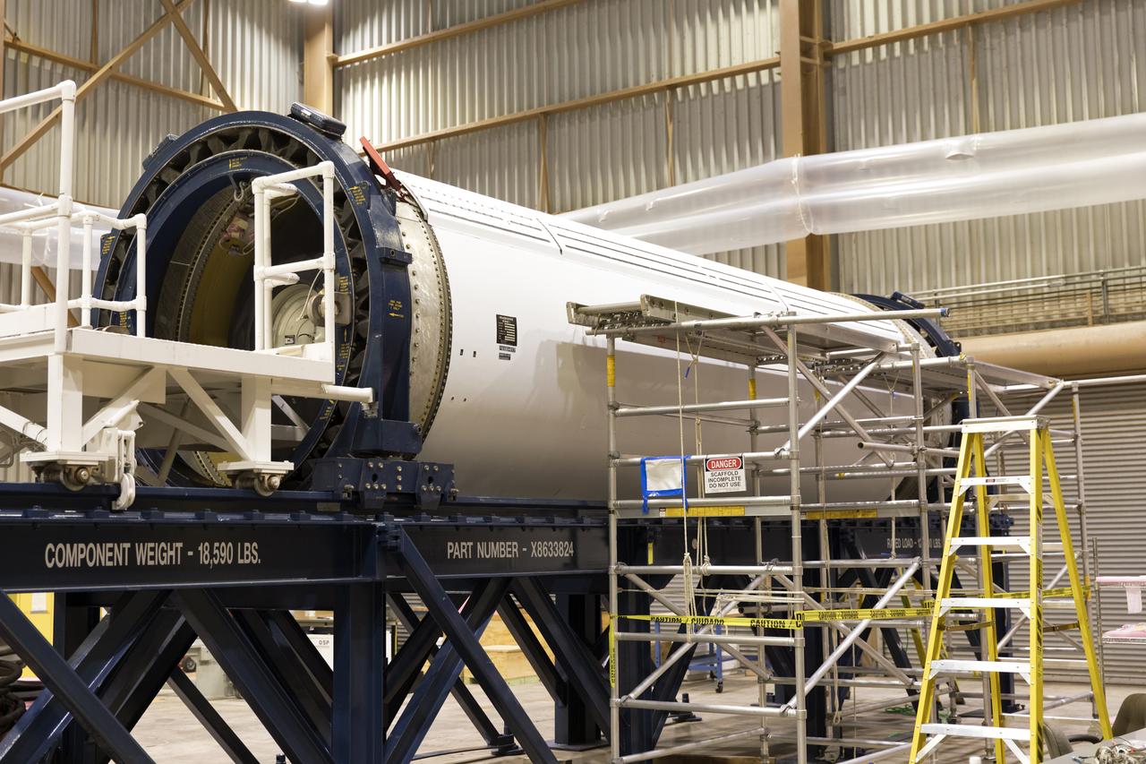 The ground test motor for Orion's Launch Abort System (LAS) is secured on a work stand inside the Rotation, Processing and Surge Facility on July 31, 2018, at NASA's Kennedy Space Center in Florida. It will be inspected and prepared for transport to Space Launch Complex 46 (SLC-46) at Cape Canaveral Air Force Station for mechanical fit testing. This inert motor will not be used for flight, but will be used to certify flight hardware assembly in preparation for a full-stress test of the LAS, called Ascent Abort-2 (AA-2) flight test, scheduled for April 2019. During the test, the booster will launch from SLC 46, carrying a fully functional LAS and a 22,000-pound Orion test vehicle to an altitude of 31,000 feet and traveling at more than 1,000 miles an hour. The test will verify the LAS can steer the crew module and astronauts aboard to safety in the event of an issue with the Space Launch System (SLS) rocket when the spacecraft is under the highest aerodynamic loads it will experience during a rapid climb into space. NASA's Orion and Exploration Ground Systems programs and their contractors from Jacob's and Northrup Grumman in conjunction with the Air Force Space and Missile Center's Launch Operations branch are performing the pathfinding exercises and flight operations for AA-2.