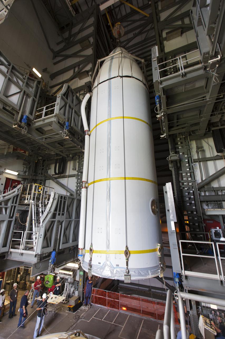Encapsulated in its payload fairing, NASA's Parker Solar Probe is lifted by a crane for mating to a United Launch Alliance Delta IV Heavy rocket at Cape Canaveral Air Force Station's Space Launch Complex 37 on Tuesday, July 31, 2018. The Parker Solar Probe is being prepared for a mission to perform the closest-ever observations of a star when it travels through the Sun's atmosphere, called the corona. The probe will rely on measurements and imaging to revolutionize our understanding of the corona and the Sun-Earth connection.