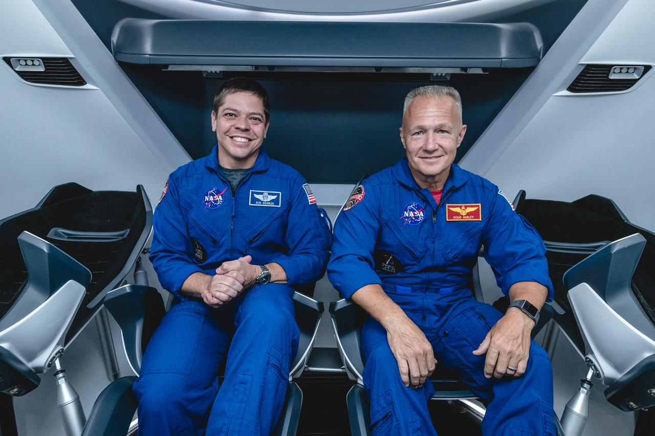 NASA astronauts, from left, Bob Behnken and Doug Hurley, assigned to fly on SpaceX's Demo-2 test flight of its Crew Dragon, are inside a mockup of the spacecraft at NASA's Johnson Space Center in Houston on Aug. 2, 2018, ahead of the agency's announcement of their commercial crew assignment Aug. 3. Nine U.S. astronauts were selected for commercial crew flight assignments on the first test flights and operational missions for SpaceX's Crew Dragon and Boeing's CST-100 Starliner.