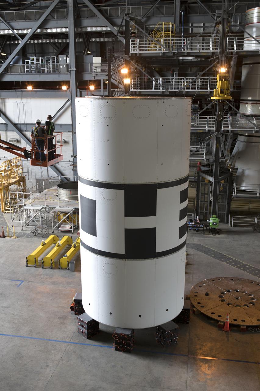 The aeroshells for Orion's Launch Abort System (LAS) are being stacked in High Bay 4 of the Vehicle Assembly Building on Aug. 3, 2018, at NASA's Kennedy Space Center in Florida. The aeroshells are being prepared for a full-stress test of the LAS, called Ascent Abort-2 (AA-2) flight test, scheduled for April 2019. During the test, a booster will launch from Space Launch Complex 46 at Cape Canaveral Air Force Station, carrying a fully functional LAS and a 22,000-pound Orion test vehicle to an altitude of 31,000 feet and traveling at more than 1,000 miles an hour. The test will verify the LAS can steer the crew module and astronauts aboard to safety in the event of an issue with the Space Launch System (SLS) rocket when the spacecraft is under the highest aerodynamic loads it will experience during a rapid climb into space. Orion is being prepared for its first integrated uncrewed flight atop the SLS on Exploration Mission-1.