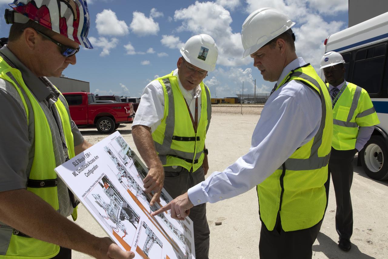 NASA Administrator Jim Bridenstine (right) is briefed by Cliff Lanham, Mobile Launcher Project Manager (center), on testing of the mobile launcher that will support the agency's Space Launch System rocket and Orion spacecraft that will liftoff for trips to the Moon, Mars and deep space. Bridenstine made his first official visit to the NASA's Florida spaceport on Aug. 6 and 7, 2018.