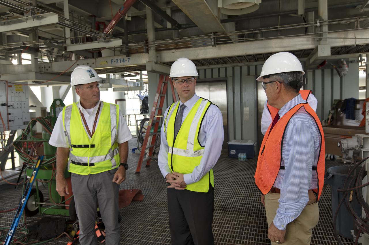 NASA Administrator Jim Bridenstine (center) is briefed by Cliff Lanham, Mobile Launcher Project Manager (left) and Kennedy Space Center Director Bob Cabana on testing of the mobile launcher that will support the agency's Space Launch System rocket and Orion spacecraft that will liftoff on trips to the Moon, Mars and deep space. Bridenstine made his first official visit to the NASA's Florida spaceport on Aug. 6 and 7, 2018.