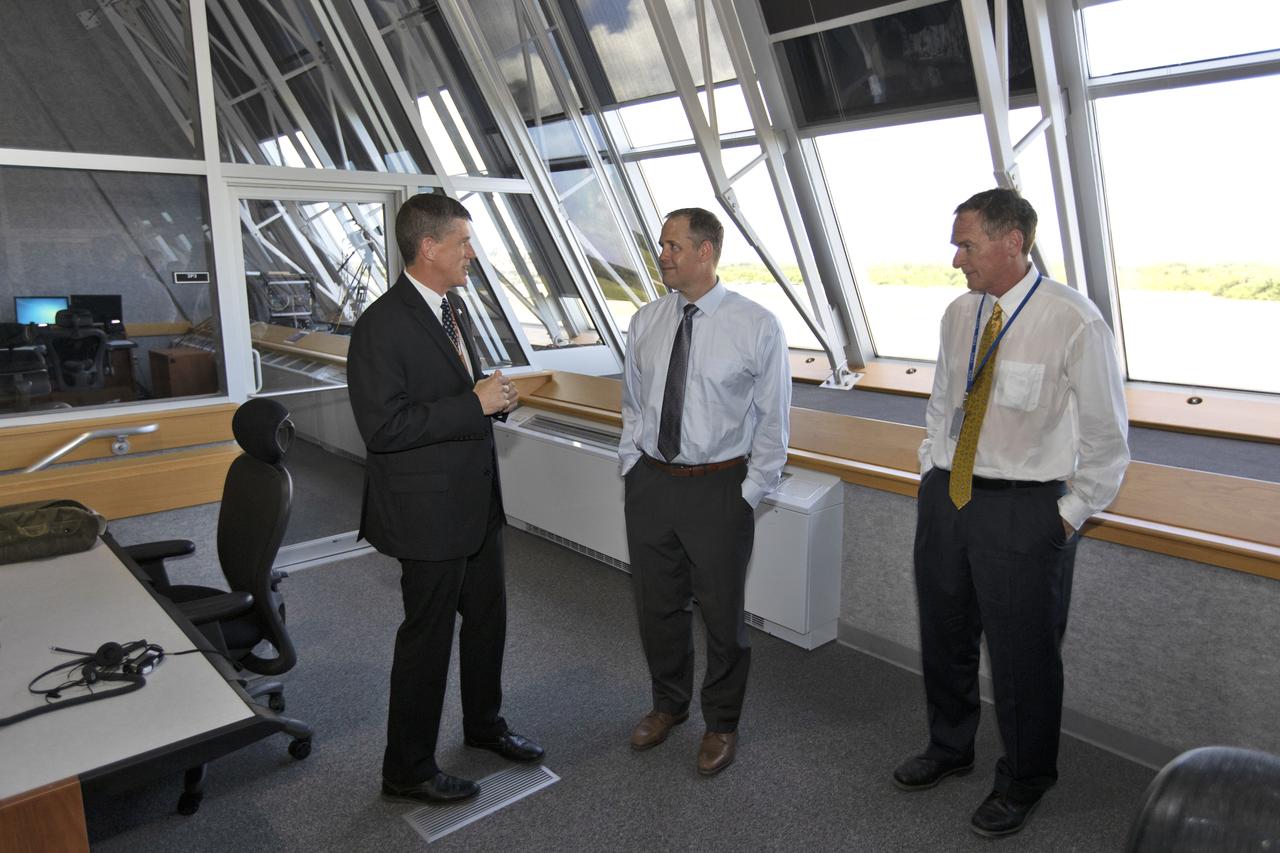 NASA Administrator Jim Bridenstine (center) is briefed by Jeremy Graeber, chief of Test, Launch and Recovery Operations (left), and Mike Bolger, Exploration Ground Systems program manager, during a tour of the Firing Room of the Launch Control Center at NASA's Kennedy Space Center. Bridenstine made his first official visit to the Florida spaceport on Aug. 6 and 7, 2018.