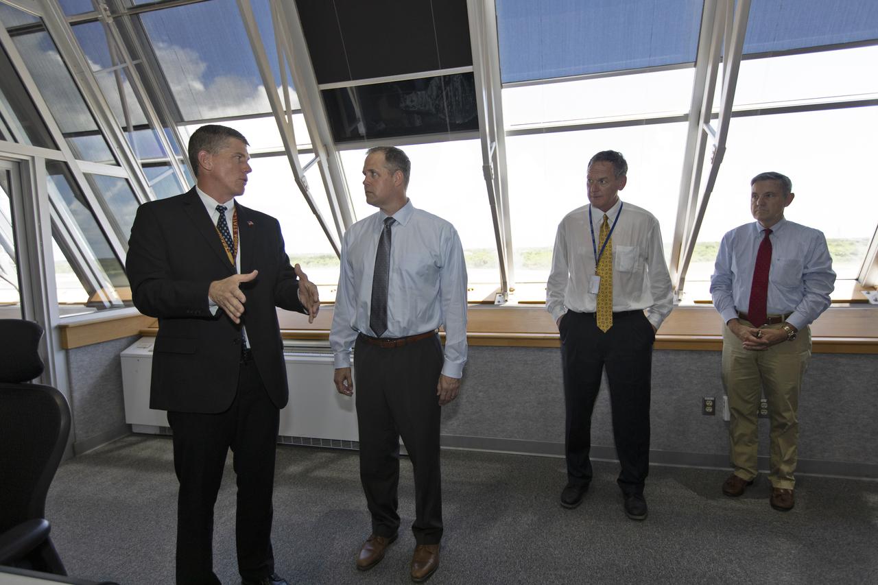 NASA Administrator Jim Bridenstine (second from the left) is briefed by Jeremy Graeber, chief of Test, Launch and Recovery Operations (left), Mike Bolger, Exploration Ground Systems program manager, (second from the right), and Kennedy Space Center Director Bob Cabana, during a tour of the Firing Room of the Launch Control Center. Bridenstine made his first official visit to the Florida spaceport on Aug. 6 and 7, 2018.