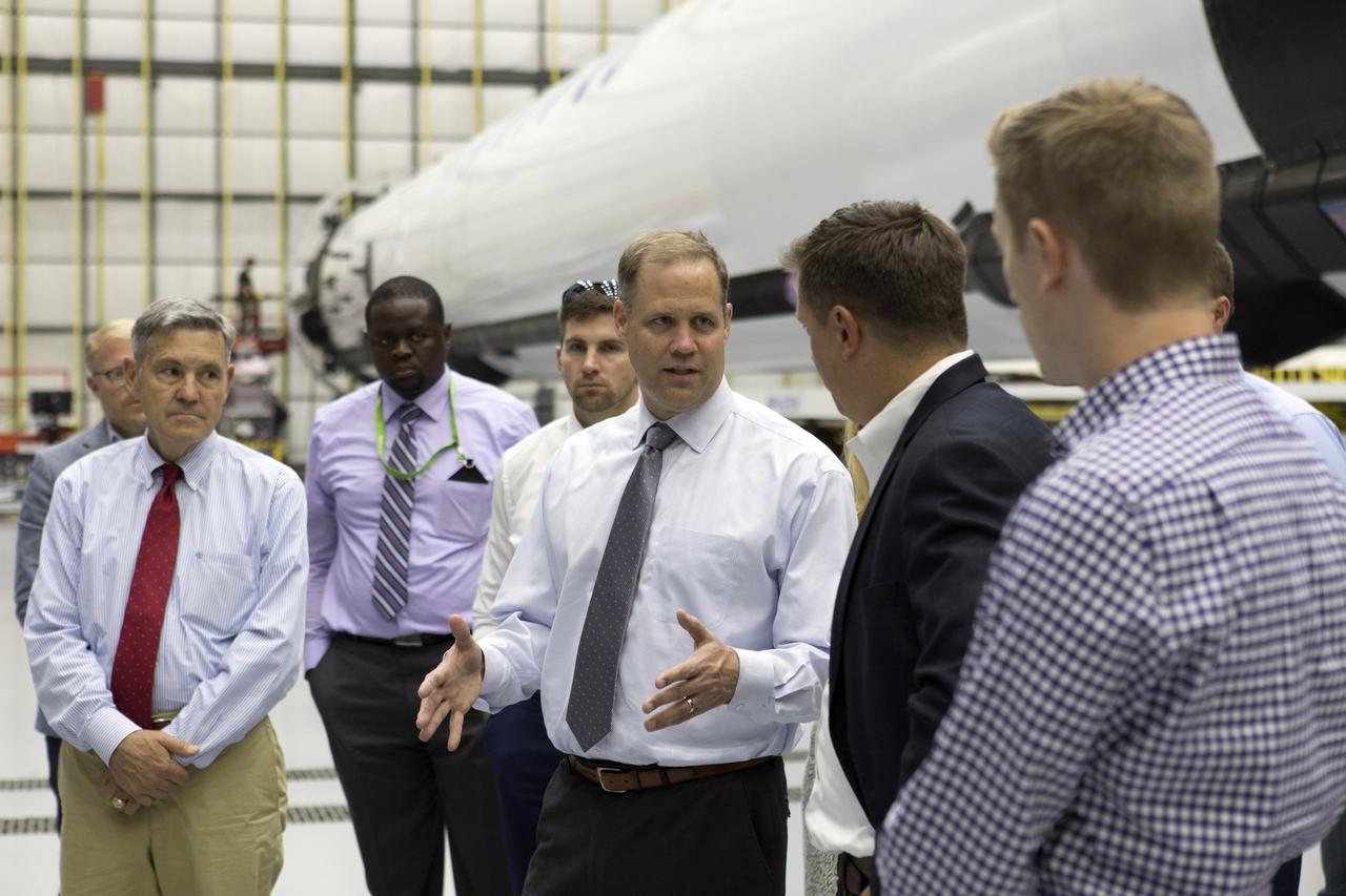 NASA Administrator Jim Bridenstine, center, tours SpaceX facilities on Aug. 8, 2018, at the agency's Kennedy Space Center in Florida. At far left is Kennedy Space Center Director Bob Cabana. Inside the SpaceX hangar at Launch Complex 39A, Bridenstine visited with workers and was updated on SpaceX accomplishments for NASA's Commercial Crew Program.