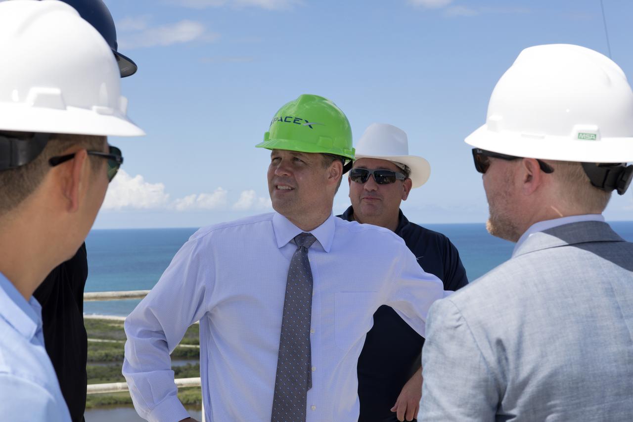 NASA Administrator Jim Bridenstine, center, in the green safety helmet, tours SpaceX Launch Complex 39A, on Aug. 8, 2018, at the agency's Kennedy Space Center in Florida. Bridenstine received updates on SpaceX accomplishments for NASA's Commercial Crew Program.