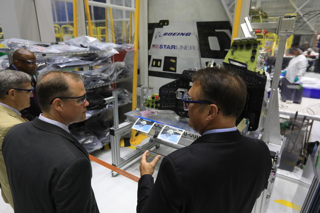 In the Commercial Crew and Cargo Processing Facility at NASA's Kennedy Space Center, agency Administrator Jim Bridenstine (center) is briefed Center Director Bob Cabana (left), and John Mulholland, vice president and manager of Boeing's CST-100 Starliner Program (center), and. The C3PF is the production and processing home of Boeing’s Starliner spacecraft. Bridenstine made his first official visit to NASA's Kennedy Space Center on Aug. 6 and 7, 2018.
