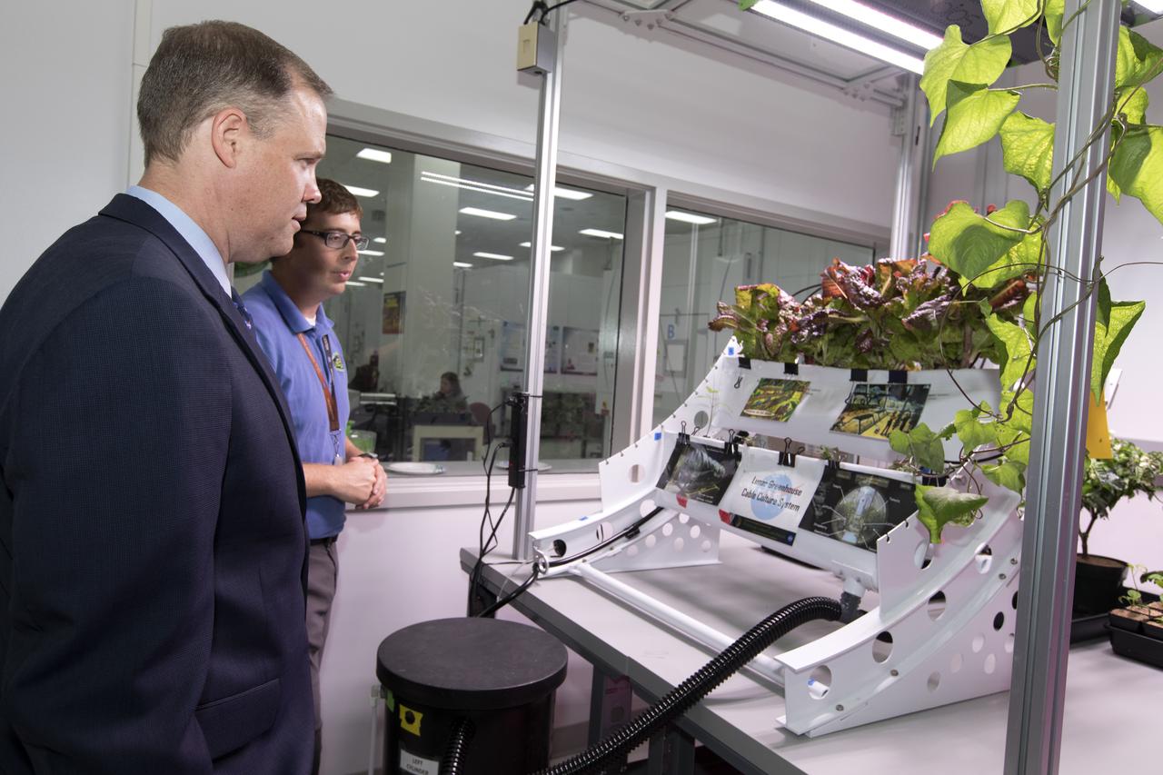 NASA Administrator Jim Bridenstine, at left, tours a plant research laboratory inside the Space Station Processing Facility (SSPF) at NASA's Kennedy Space Center in Florida, on Aug. 7, 2018. At right is Matt Romeyn, project scientist. Bridenstine received updates on research and technology accomplishments during his visit to the SSPF.