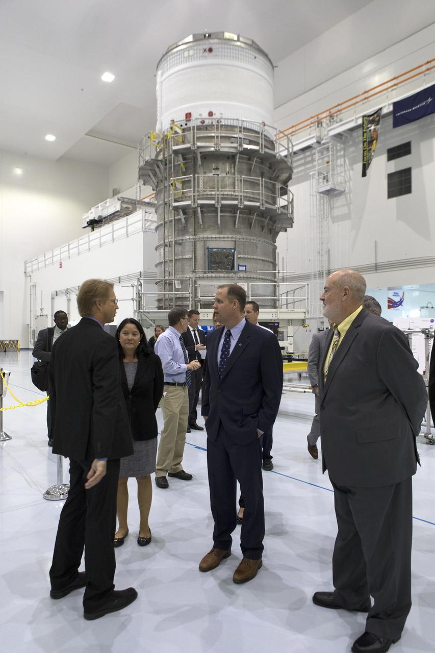 NASA Administrator Jim Bridenstine, at right, tours the high bay inside the Space Station Processing Facility (SSPF), on Aug. 7, 2018, at NASA's Kennedy Space Center in Florida. From left, Carlos Calle, lead scientist in the Electrostatic and Surface Physics Laboratory, and Dr. Robert Youngquist, lead, Applied Physics Laboratory, explain electrostatic dust shield technology. Bridenstine also received updates on research and technology accomplishments during his visit to the SSPF.