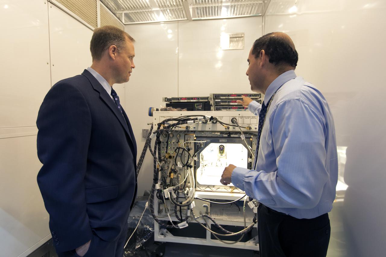 NASA Administrator Jim Bridenstine, left, tours the Space Station Processing Facility at NASA's Kennedy Space Center in Florida, on Aug. 7, 2018. Bryan Onate, at right, Advanced Plant Habitat (APH) project manager, explains a component of the APH control system. Bridenstine also received updates on research and technology accomplishments.