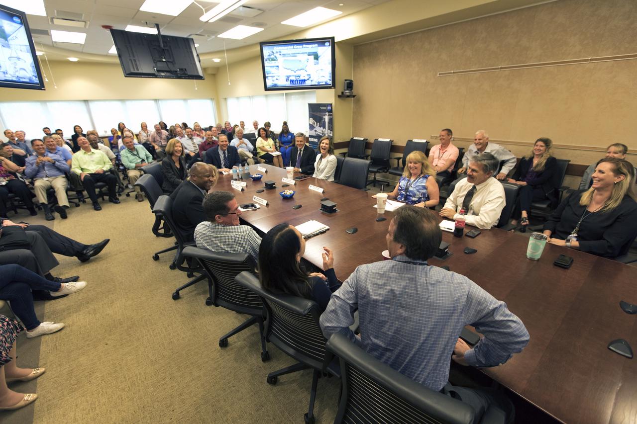 NASA Administrator Jim Bridenstine, seated at the far end of table, center, visited the agency's Kennedy Space Center in Florida, on Aug. 7, 2018. Bridenstine talked with Commercial Crew Program (CCP) leadership inside a conference room at the Operations and Checkout Building. At right is Kennedy Center Director Bob Cabana. At left is Kathy Lueders, CCP manager. The administrator also toured facilities and received updates on the program.