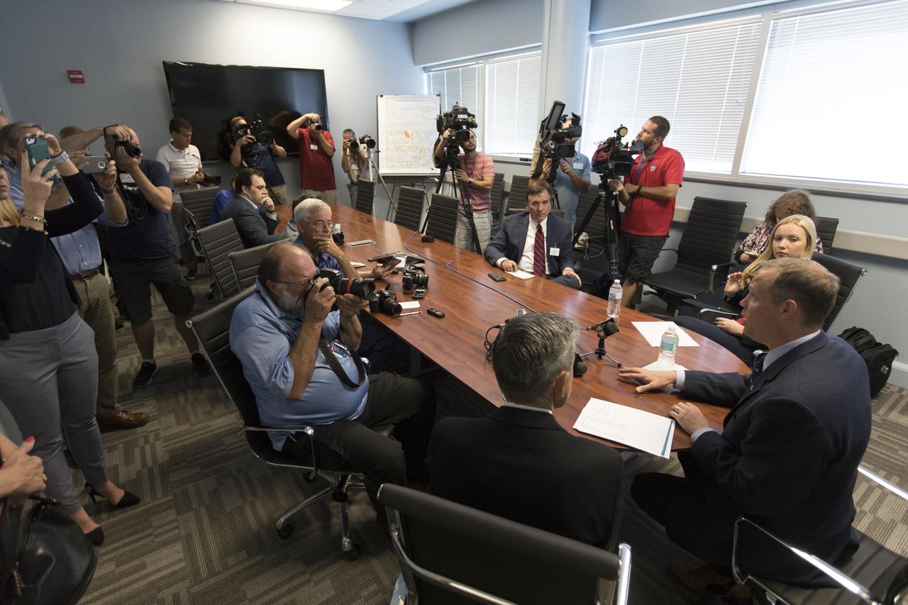 NASA Administrator Jim Bridenstine, seated at far right, talks with members of the local media in a conference room inside the Space Life Sciences Laboratory during his tour of Kennedy Space Center in Florida, on Aug. 7, 2018. Seated at his left is Kennedy Center Director Bob Cabana. The administrator toured Kennedy facilities and received updates on various center accomplishments.