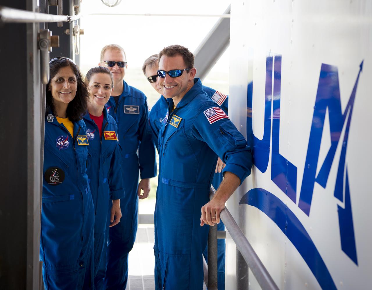 From left, commercial crew astronauts Suni Williams, Nicole Mann, Eric Boe, Chris Ferguson and Josh Cassada visit Kennedy Space Center (KSC) in Florida shortly after they were officially assigned to fly on Boeing’s CST-100 Starliner. The astronauts stopped by Boeing’s Commercial Crew and Cargo Processing Facility (C3PF) at Kennedy and Space Launch Complex 41 at Cape Canaveral Air Force Station to view progress on the Starliner and the launch pad. Boe, Ferguson and Mann will fly on Starliner in Boeing’s upcoming Crew Flight Test to the International Space Station (ISS). Cassada and Williams are assigned to Boeing’s first operational mission to the ISS. Photo credit: Boeing