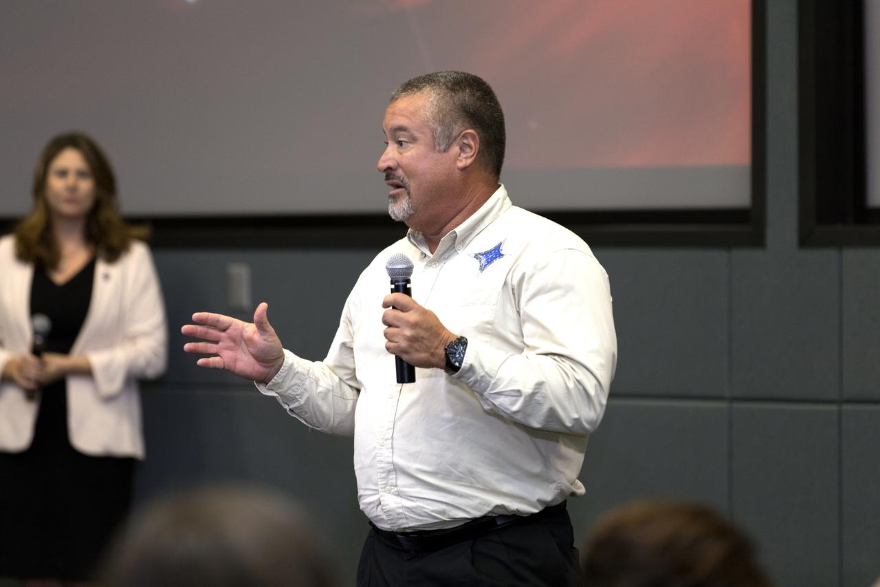 In the Kennedy Space Center's Operations and Support Building II, Thursday, Aug. 9, 2018, members of the media participate in a prelaunch mission briefing on NASA's Parker Solar Probe. Speaking to the media is Omar Baez, launch director, NASA Kennedy Space Center. The Parker Solar Probe will lift off on a United Launch Alliance Delta IV Heavy rocket from Space Launch Complex 37 at Cape Canaveral Air Force Station in Florida. The spacecraft was built by Applied Physics Laboratory of Johns Hopkins University in Laurel, Maryland. The mission will perform the closest-ever observations of a star when it travels through the Sun's atmosphere, called the corona. The probe will rely on measurements and imaging to revolutionize our understanding of the corona and the Sun-Earth connection.