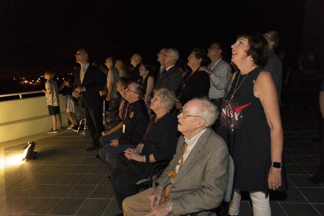 Dr. Eugene Parker (seated in the foreground), a pioneer in heliophysics and S. Chandrasekhar distinguished service professor emeritus for the Department of Astronomy and Astrophysics at the University of Chicago, watches the launch of NASA's Parker Solar Probe. This is the first agency mission named for a living person. Standing behind Parker is Nicky Fox, Parker Solar Probe project scientist at Johns Hopkins Applied Physics Laboratory. The liftoff took place at 3:31 a.m. EDT on Sunday, Aug. 12, 2018. The spacecraft was built by the Johns Hopkins University Applied Physics Laboratory in Laurel, Maryland. The mission will perform the closest-ever observations of a star when it travels through the Sun's atmosphere, called the corona. The probe will rely on measurements and imaging to revolutionize our understanding of the corona and the Sun-Earth connection.