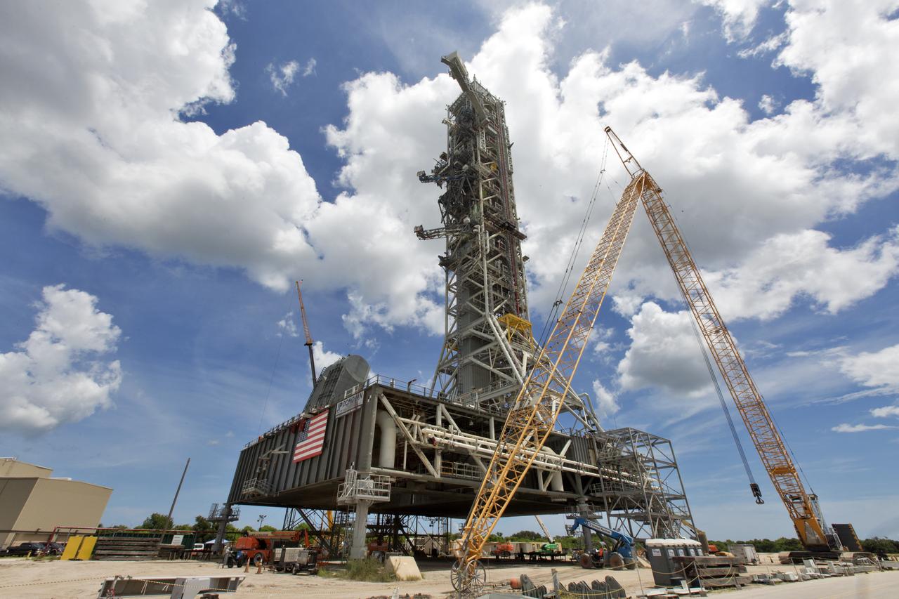 A swing test of the Orion crew access arm, topmost umbilical, is in progress on the mobile launcher at NASA's Kennedy Space Center in Florida, on Aug. 21, 2018. The crew access arm is located at about the 274-foot level on the mobile launcher tower. It will rotate from its retracted position and interface with the Orion crew hatch location to provide entry to the Orion crew module. Exploration Ground Systems extended all of the launch umbilicals on the ML tower to test their functionality before the mobile launcher, atop crawler-transporter 2, is moved to Launch Pad 39B and the Vehicle Assembly Building.