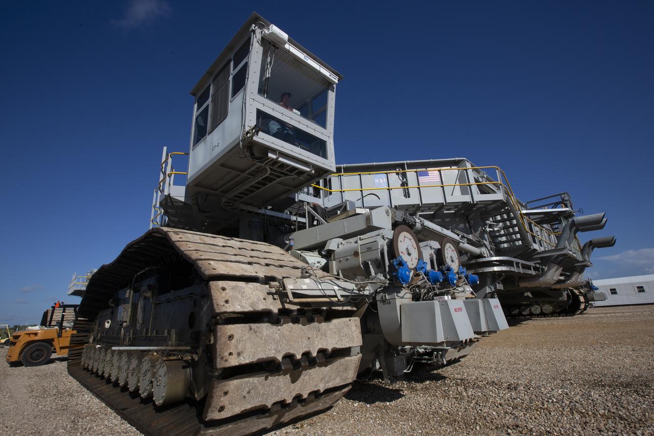 Sam Dove, a crawler-transporter engineer with Jacobs on the Test and Operations Support Contract, is inside the operator cab of crawler-transporter 2 on the crawlerway at NASA's Kennedy Space Center in Florida, on Aug. 27, 2018. CT-2 will carry the mobile launcher for the first time to Launch Pad 39B for a fit check of key systems that will support the launch of the agency's Space Launch System rocket and Orion spacecraft on Exploration Mission-1. The crawler also will carry the mobile launcher to the Vehicle Assembly Building for system checks and fit checks with the 10 levels of new work platforms in High Bay 3.