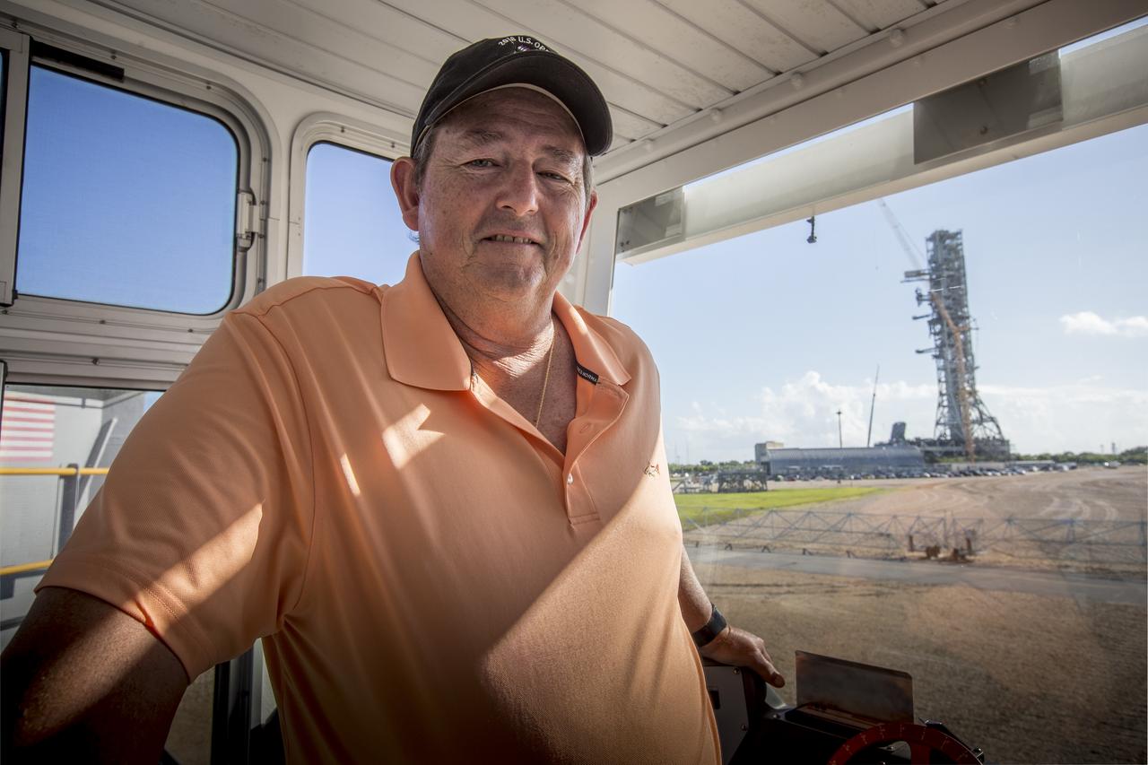 Bob Myers, a mechanical systems engineer with ERC on the Test and Operations Support Contract, is inside the operator cab of crawler-transporter 2 on the crawlerway at NASA's Kennedy Space Center in Florida, on Aug. 27, 2018. CT-2 will carry the mobile launcher for the first time to Launch Pad 39B for a fit check of key systems that will support the launch of the agency's Space Launch System rocket and Orion spacecraft on Exploration Mission-1. The crawler also will carry the mobile launcher to the Vehicle Assembly Building for system checks and fit checks with the 10 levels of new work platforms in High Bay 3.
