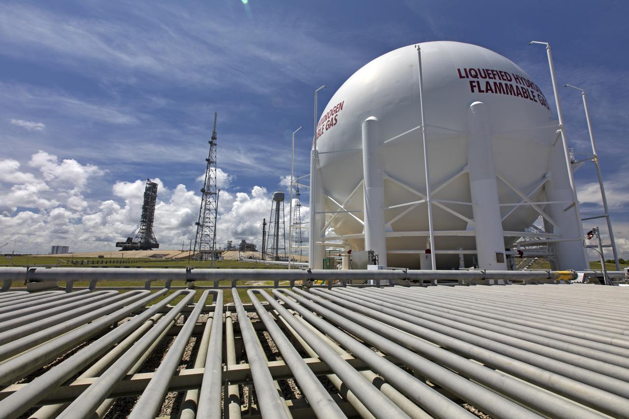 A liquid hydrogen storage tank is in view as NASA's mobile launcher (ML) atop crawler-transporter 2 makes its way up the ramp at Launch Pad 39B on Aug. 31, 2018, at the agency's Kennedy Space Center in Florida. The ML will undergo a fit check, followed by several days of systems testing. The 380-foot-tall mobile launcher is equipped with the crew access arm and several umbilicals that will provide power, environmental control, pneumatics, communication and electrical connections to NASA's Space Launch System (SLS) and Orion spacecraft. Exploration Ground Systems is preparing the ground systems necessary to launch SLS and Orion on Exploration Mission-1, missions to the Moon and on to Mars.
