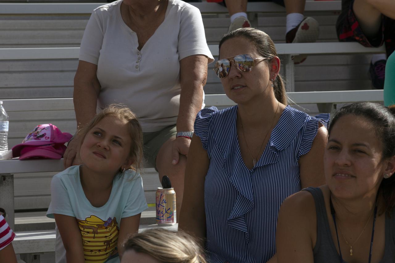 During an employee event, workers and guests watch from bleachers as NASA's mobile launcher, atop crawler-transporter 2, moves slowly along the crawlerway toward the Vehicle Assembly Building (VAB) on Sept. 7, 2018, at NASA's Kennedy Space Center in Florida. The mobile launcher underwent a fit check and several days of systems testing with the pad. This is the first time that the modified mobile launcher made the trip to the pad. The 380-foot-tall mobile launcher is equipped with the crew access arm and several umbilicals that will provide power, environmental control, pneumatics, communication and electrical connections to the agency's Space Launch System and Orion spacecraft. The mobile launcher will spend seven months in the VAB undergoing testing. Exploration Ground Systems is preparing the ground systems necessary to launch SLS and Orion on Exploration Mission-1, missions to the Moon and on to Mars.