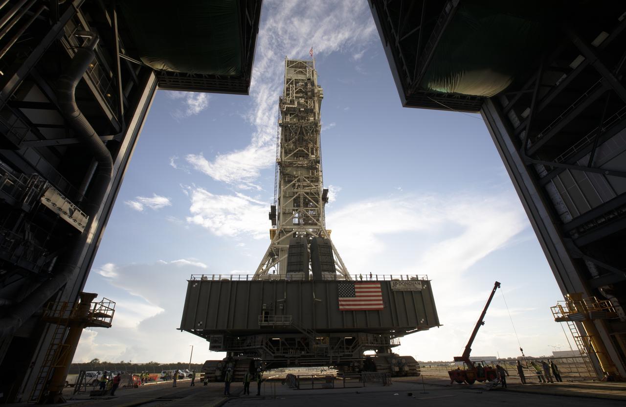 NASA's mobile launcher, atop crawler-transporter 2, is at the entrance to High Bay 3 at the Vehicle Assembly Building (VAB) on Sept. 8, 2018, at NASA's Kennedy Space Center in Florida. The mobile launcher departed Launch Pad 39B after several days of testing with the pad. This is the first time that the modified mobile launcher made the trip to the pad and the VAB. The mobile launcher will spend seven months in the VAB undergoing testing. The 380-foot-tall structure is equipped with the crew access arm and several umbilicals that will provide power, environmental control, pneumatics, communication and electrical connections to the agency's Space Launch System and Orion spacecraft. Exploration Ground Systems is preparing the ground systems necessary to launch SLS and Orion on Exploration Mission-1, missions to the Moon and on to Mars.