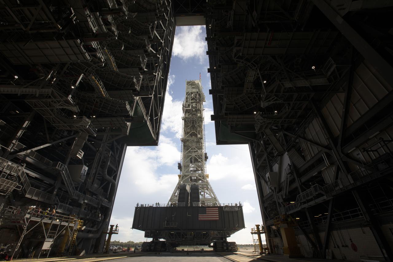 NASA's mobile launcher, atop crawler-transporter 2, begins the move into High Bay 3 at the Vehicle Assembly Building (VAB) on Sept. 8, 2018, at NASA's Kennedy Space Center in Florida. The mobile launcher departed Launch Pad 39B after several days of testing with the pad. This is the first time that the modified mobile launcher made the trip to the pad and the VAB. The mobile launcher will spend seven months in the VAB undergoing testing. The 380-foot-tall structure is equipped with the crew access arm and several umbilicals that will provide power, environmental control, pneumatics, communication and electrical connections to the agency's Space Launch System and Orion spacecraft. Exploration Ground Systems is preparing the ground systems necessary to launch SLS and Orion on Exploration Mission-1, missions to the Moon and on to Mars.