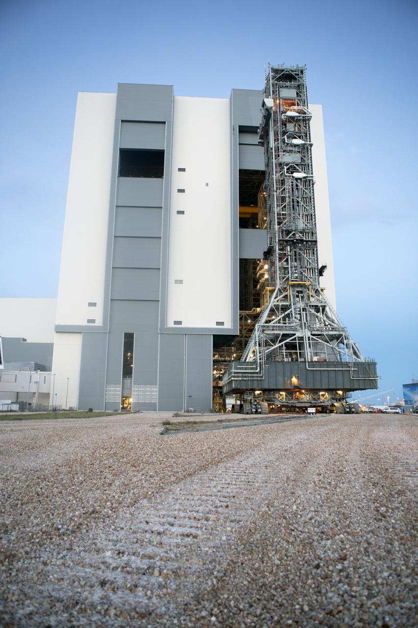 NASA's mobile launcher, atop crawler-transporter 2, is at the entrance to High Bay 3 at the Vehicle Assembly Building (VAB) on Sept. 8, 2018, at NASA's Kennedy Space Center in Florida. The mobile launcher departed Launch Pad 39B after several days of testing with the pad. This is the first time that the modified mobile launcher made the trip to the pad and the VAB. The mobile launcher will spend seven months in the VAB undergoing testing. The 380-foot-tall structure is equipped with the crew access arm and several umbilicals that will provide power, environmental control, pneumatics, communication and electrical connections to the agency's Space Launch System and Orion spacecraft. Exploration Ground Systems is preparing the ground systems necessary to launch SLS and Orion on Exploration Mission-1, missions to the Moon and on to Mars.