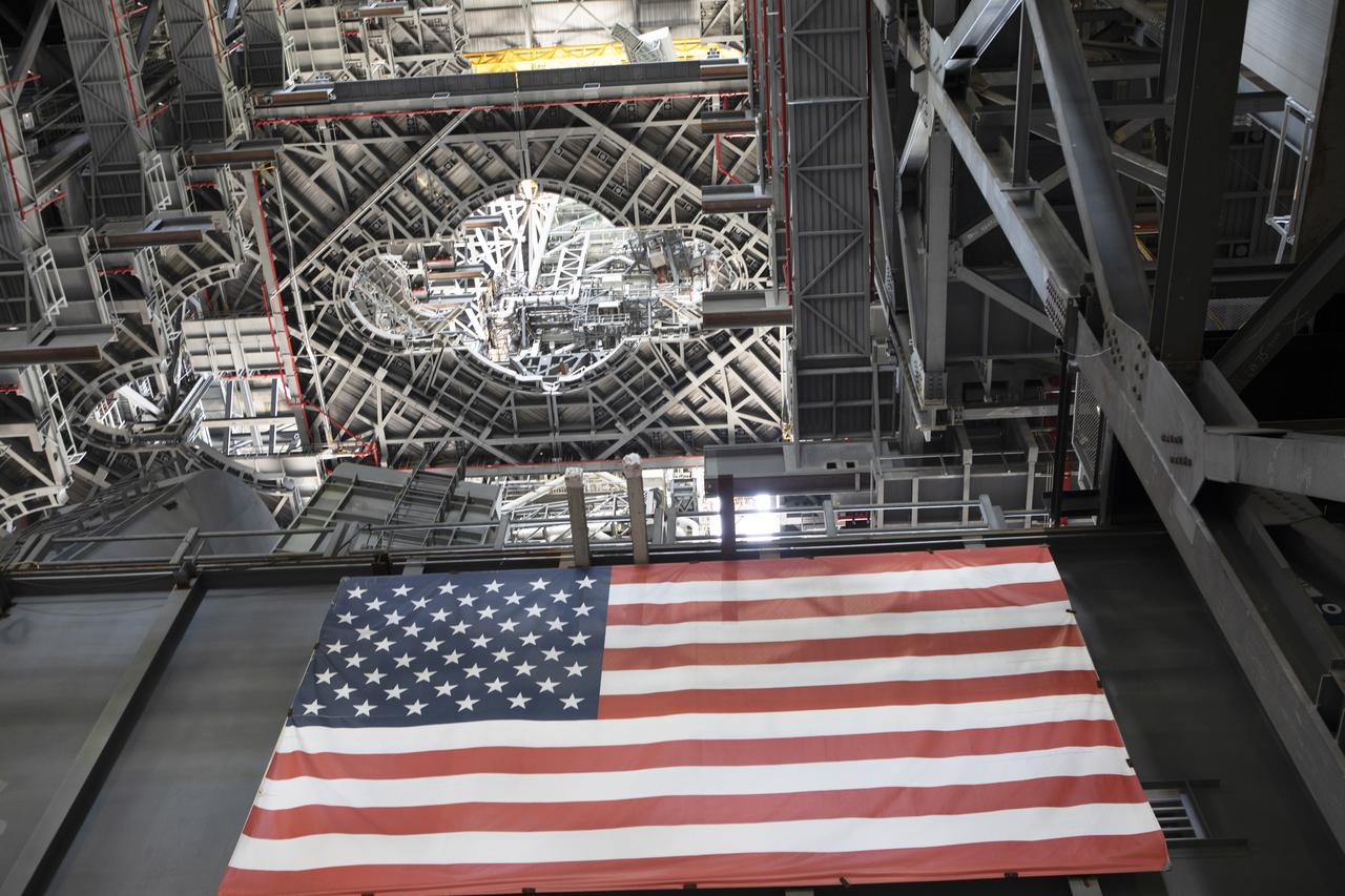 NASA's mobile launcher is inside High Bay 3 at the Vehicle Assembly Building (VAB) on Sept. 11, 2018, at NASA's Kennedy Space Center in Florida. Several levels of the new work platforms have been extended around the mobile launcher tower. The American flag is in view on the base of the structure. The mobile launcher will spend seven months in the VAB undergoing testing. The 380-foot-tall structure is equipped with the crew access arm and several umbilicals that will provide power, environmental control, pneumatics, communication and electrical connections to the agency's Space Launch System and Orion spacecraft. Exploration Ground Systems is preparing the ground systems necessary to launch SLS and Orion on Exploration Mission-1, missions to the Moon and on to Mars.