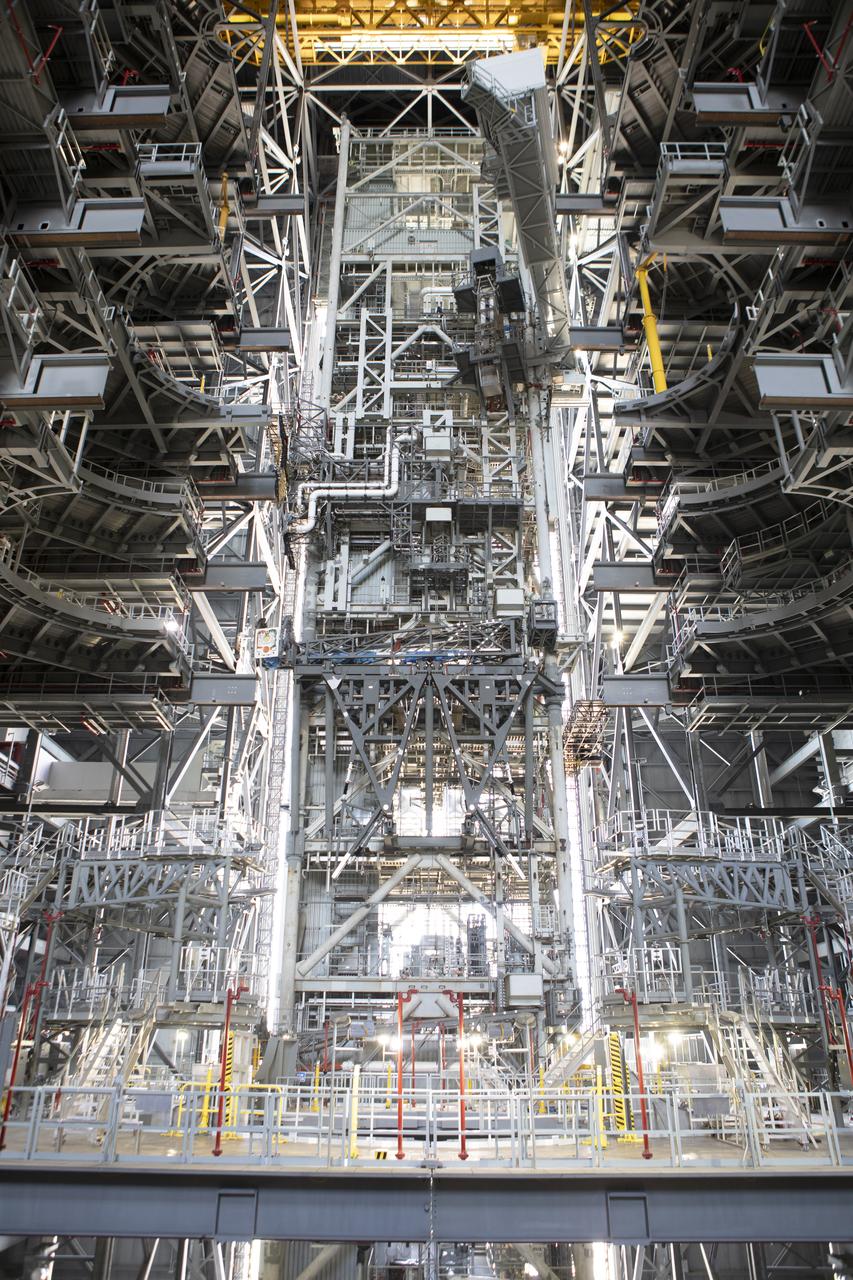 NASA's mobile launcher is inside High Bay 3 at the Vehicle Assembly Building (VAB) on Sept. 11, 2018, at NASA's Kennedy Space Center in Florida. In view are several levels of the new work platforms that will surround the mobile launcher during stacking and processing for launch. In view at the top is the crew access arm, which is being extended. The mobile launcher will spend seven months in the VAB undergoing testing. The 380-foot-tall structure is equipped with the crew access arm and several umbilicals that will provide power, environmental control, pneumatics, communication and electrical connections to the agency's Space Launch System and Orion spacecraft. Exploration Ground Systems is preparing the ground systems necessary to launch SLS and Orion on Exploration Mission-1, missions to the Moon and on to Mars.