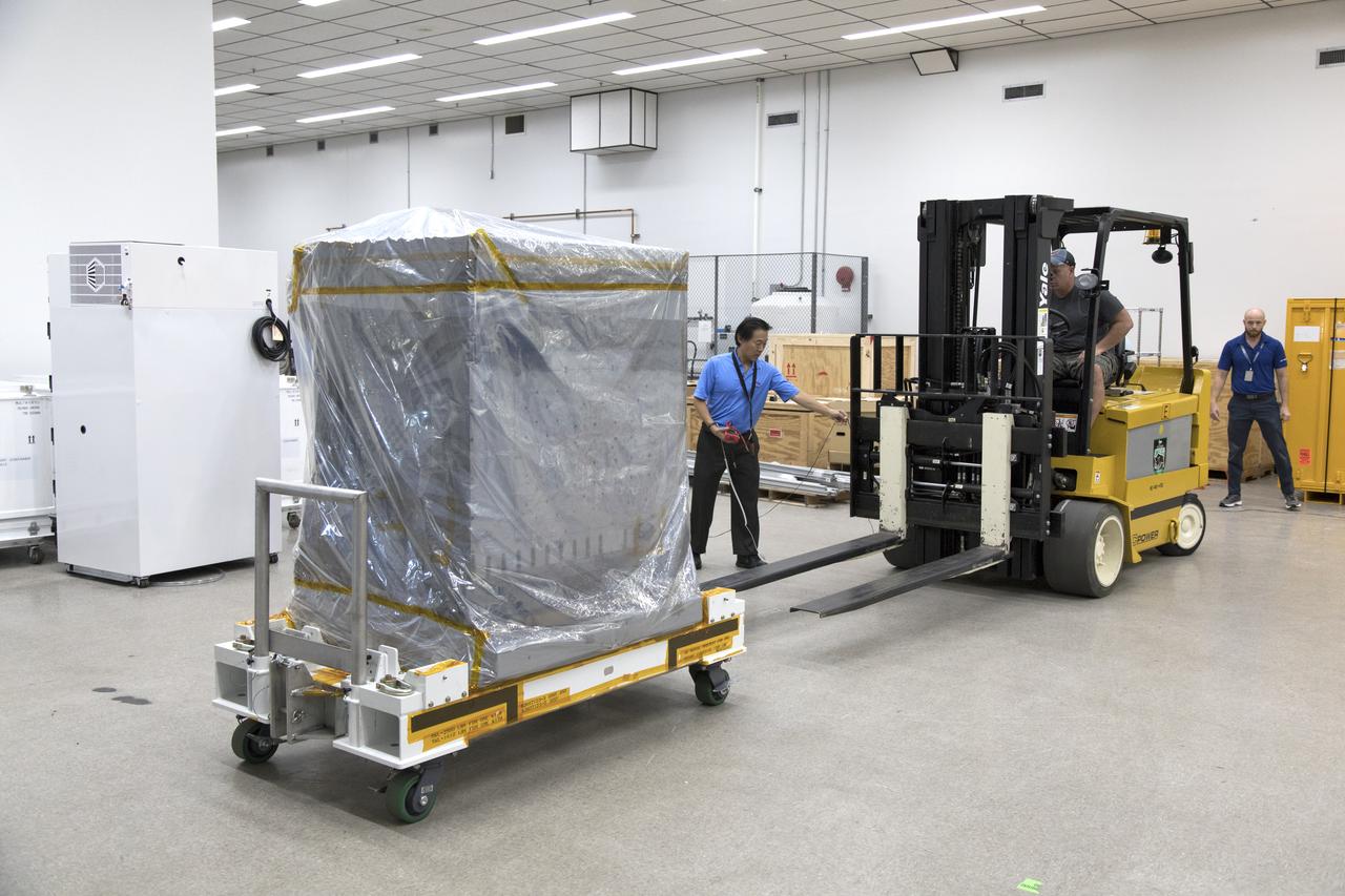 Workers prepare the Robotic Refueling Mission-3 (RRM3) payload to be transferred from the Space Station Processing Facility high bay to the Payload Hazardous Servicing Facility on Oct. 3, 2018, at NASA's Kennedy Space Center in Florida. The payload will be carried to the International Space Station on SpaceX's 16th Commercial Resupply Services mission. RRM3 demonstrates the transfer of xenon gas and liquid methane in microgravity, and advances technologies for storing and manipulating these cryogenic fuels robotically. RRM3 also supports development of technology for the Restore-L mission, a robotic spacecraft equipped to service satellites in-orbit.