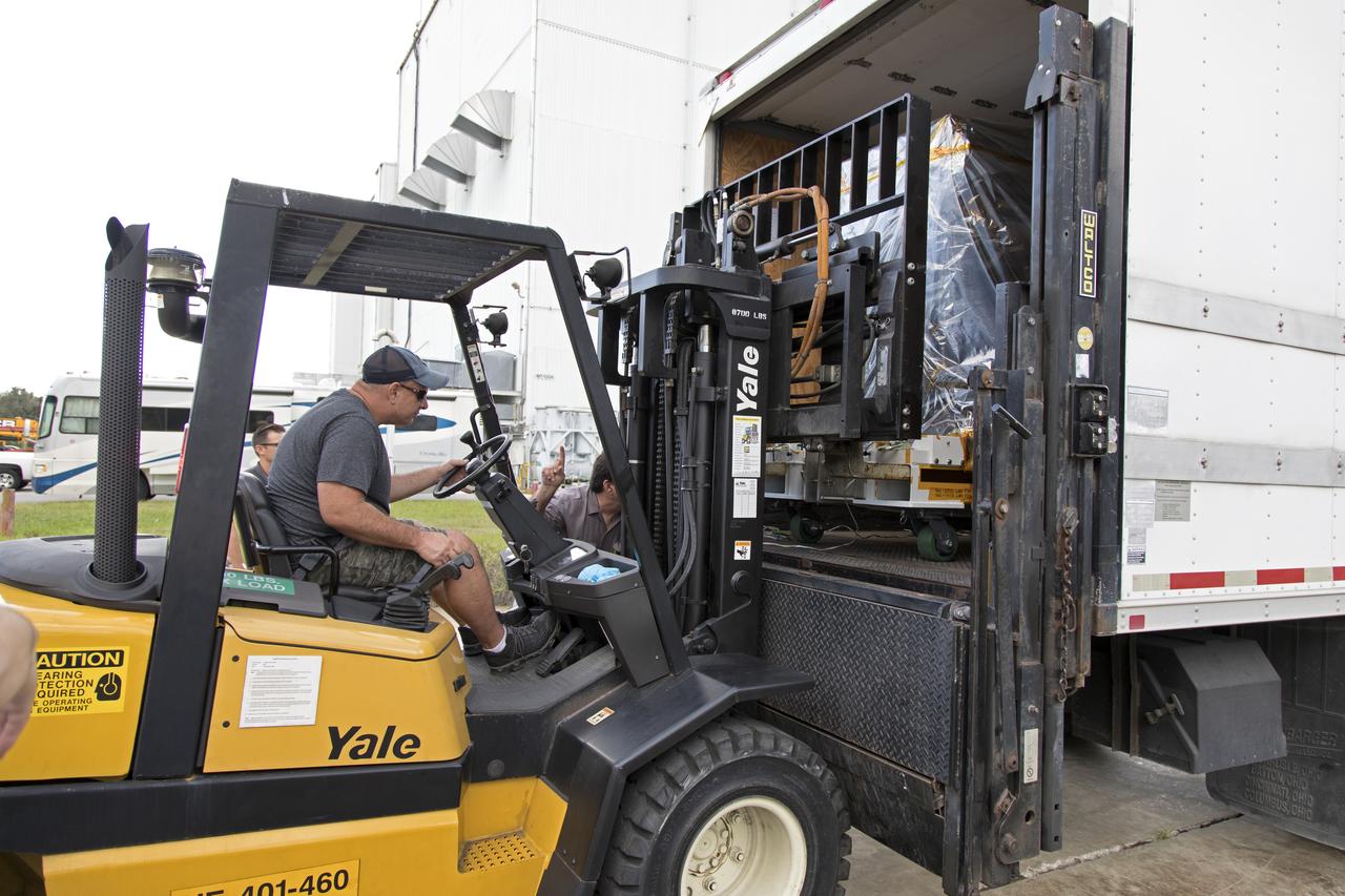 A worker uses a forklift to unload the Robotic Refueling Mission-3 (RRM3) payload from a truck at the Payload Hazardous Servicing Facility on Oct. 3, 2018, at NASA's Kennedy Space Center in Florida. The payload will be carried to the International Space Station on SpaceX's 16th Commercial Resupply Services mission. RRM3 demonstrates the transfer of xenon gas and liquid methane in microgravity, and advances technologies for storing and manipulating these cryogenic fuels robotically. RRM3 also supports development of technology for the Restore-L mission, a robotic spacecraft equipped to service satellites in-orbit.