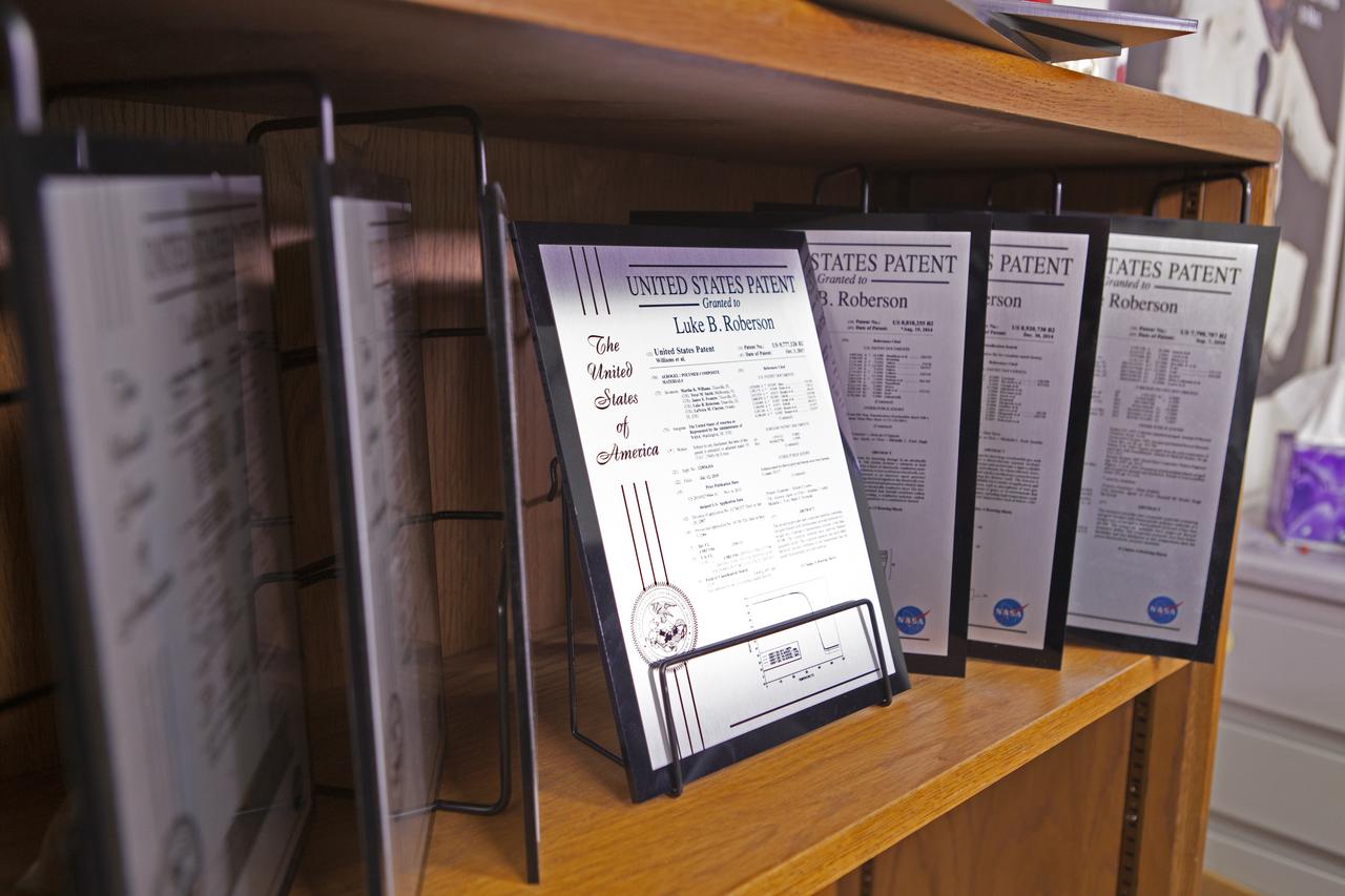Kennedy Space Center’s Luke Roberson, a principal investigator with the flight technology branch, has received several patents from the United States Patent and Trademark Office. Certificates recognizing those patents are on display in his office at the Florida spaceport’s Space Station Processing Facility. 