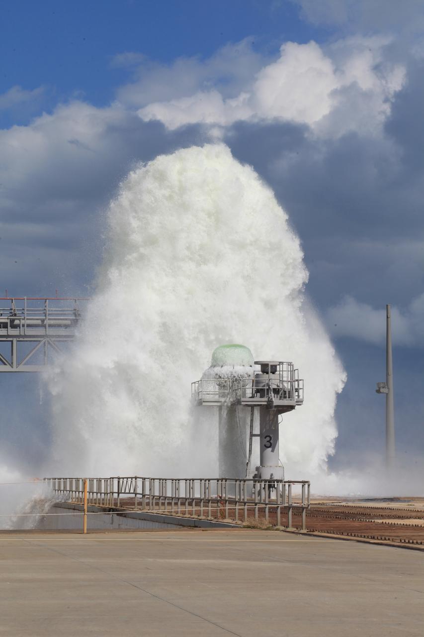 A flow test of the Ignition Overpressure Protection and Sound Suppression water deluge system is in progress at Launch Pad 39B at NASA's Kennedy Space Center in Florida, on Oct. 15, 2018. At peak flow, the water reaches about 100 feet in the air above the pad surface. It flows at high speed from a holding tank through new and modified piping and valves, the flame trench, flame deflector nozzles and mobile launcher interface risers. The testing is part of Exploration Ground System's preparation for the new Space Launch System rocket. Modifications were made to the pad after a previous wet flow test, increasing the performance of the system. During the launch of Exploration Mission-1 and subsequent missions, this water deluge system will release about 450,000 gallons of water across the mobile launcher and Flame Deflector to reduce the extreme heat and energy generated by the rocket during ignition and liftoff.