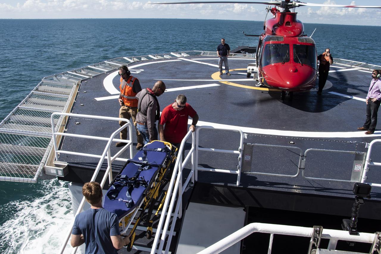 SpaceX rehearses helicopter landing and patient loading on its recovery ship, GO Searcher, practicing how the aircraft will pick up astronauts and fly them to a nearby hospital in the unlikely event of a medical emergency. The company outfitted the ship with a medical treatment facility and a helipad in the center of the vessel. When astronauts splash down into the ocean after their journey to the International Space Station on SpaceX’s Crew Dragon spacecraft, NASA and SpaceX doctors will work together to evaluate the crew onboard the vessel. Should astronauts need to be airlifted to a hospital, the helicopter also will pick up paramedics and doctors from the ship who will care for the astronauts in-flight.