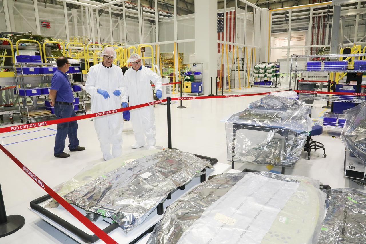 NASA astronaut Barry "Butch" Wilmore, center, tours Boeing's Commercial Crew and Cargo Processing Facility (C3PF) on Oct. 25, 2018, at NASA's Kennedy Space Center in Florida. Boeing's CST-100 Starliner will launch on its first uncrewed flight test on a United Launch Alliance Atlas V rocket. The Starliner is being developed and manufactured in partnership with NASA's Commercial Crew Program to return human spaceflight capabilities to the U.S.
