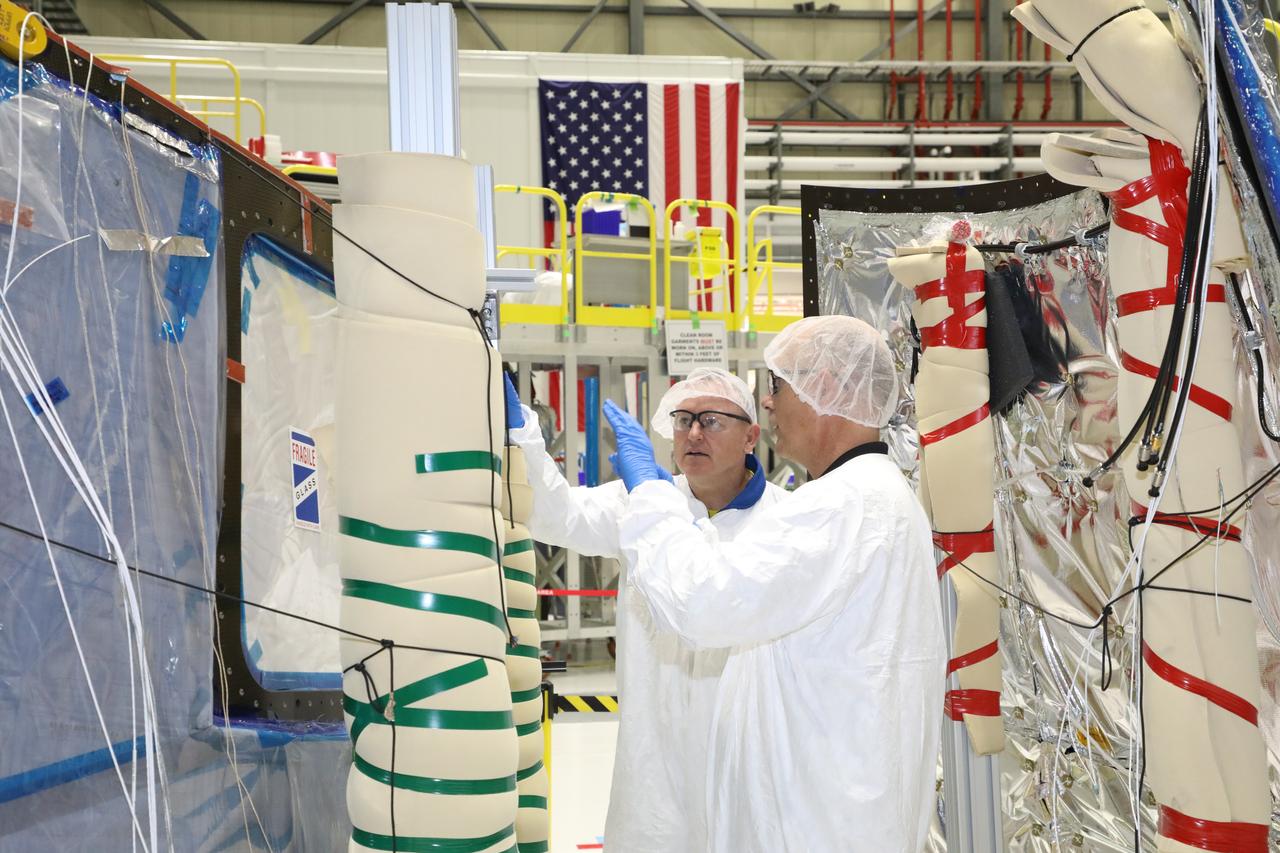 NASA astronaut Barry "Butch" Wilmore, at left, tours Boeing's Commercial Crew and Cargo Processing Facility (C3PF) on Oct. 25, 2018, at NASA's Kennedy Space Center in Florida. Boeing's CST-100 Starliner will launch on its first uncrewed flight test on a United Launch Alliance Atlas V rocket. The Starliner is being developed and manufactured in partnership with NASA's Commercial Crew Program to return human spaceflight capabilities to the U.S.