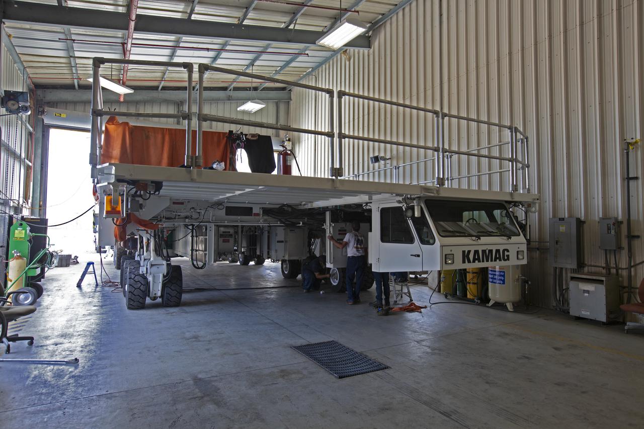 The KAMAG spacecraft transporter is inside a facility at the crawler yard at NASA's Kennedy Space Center in Florida, on Oct. 26, 2018. Jacobs technicians from the Launch Equipment Shop are welding the attach points that will hold the Orion transportation pallet in place. Testing of the pallet will be performed to support validation and verification of the attach fittings in the Multi-Payload Processing Facility. The transporter is designed to carry heavy loads, including the pallet that will contain the Orion crew module.