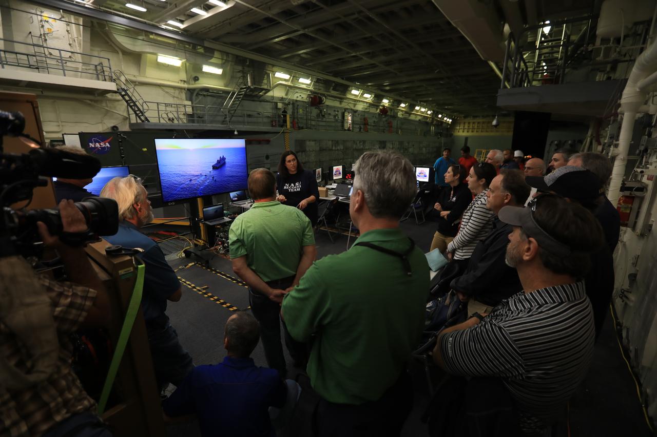 Landing and Recovery Director Melissa Jones, standing in center, gives senior leaders from around NASA a familiarization tour onboard a U.S. Navy ship on Oct. 29, 2018, as the Exploration Ground Systems (EGS) recovery team prepares for Underway Recovery Test-7 (URT-7). EGS and the U.S. Navy will use a test version of the Orion crew module, several rigid hull inflatable boats and support equipment to verify and validate processes, procedures, hardware and personnel during recovery of Orion in open waters. URTs are a series of tests to ensure all systems are go when recovering the Orion crew capsule and astronauts onboard in the future. Orion will have emergency abort capability, sustain the crew during space travel and provide safe re-entry from deep space return velocities.