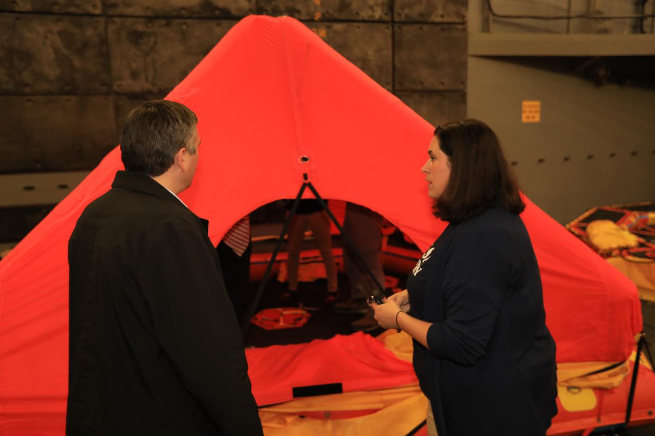 NASA Landing and Recovery Director Melissa Jones, at right, and Exploration Mission-1 Mission Manager Mike Sarafin discuss the benefits that the front porch will provide to astronauts after splashing down in the Orion crew capsule on future missions. Senior leaders from around NASA receive a familiarization tour by the Exploration Ground Systems (EGS) recovery team on Oct. 29, 2018, as they prepare for Underway Recovery Test-7 (URT-7). EGS and the U.S. Navy will use a test version of the Orion crew module, several rigid hull inflatable boats and support equipment to verify and validate processes, procedures, hardware and personnel during recovery of Orion in open waters. URTs are a series of tests to ensure all systems are go when recovering the Orion crew capsule and astronauts onboard in the future. Orion will have emergency abort capability, sustain the crew during space travel and provide safe re-entry from deep space return velocities.