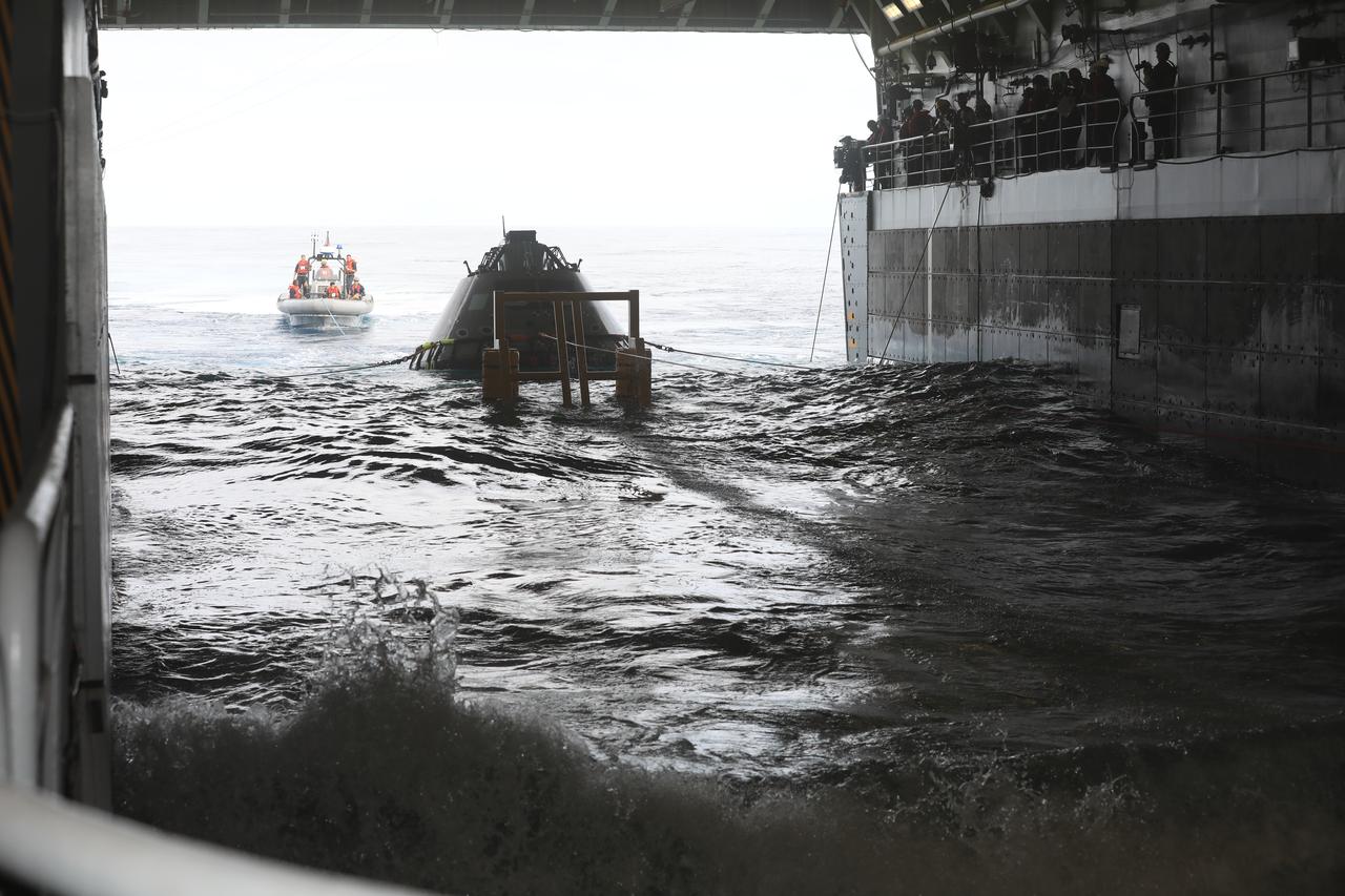 Waves crash inside the well deck of a U.S. Navy ship during Underway Recovery Test-7 (URT-7) on Oct. 30, 2018, in the Pacific Ocean. The Exploration Ground Systems (EGS) recovery team and the U.S. Navy will use a test version of the Orion crew module, several rigid hull inflatable boats and support equipment to verify and validate processes, procedures, hardware and personnel during recovery of Orion in open waters. The testing is one in a series of tests to verify and validate procedures and hardware that will be used to recover the Orion spacecraft after it splashes down in the Pacific Ocean following deep space exploration missions. Orion will have emergency abort capability, sustain the crew during space travel and provide safe re-entry from deep space return velocities.