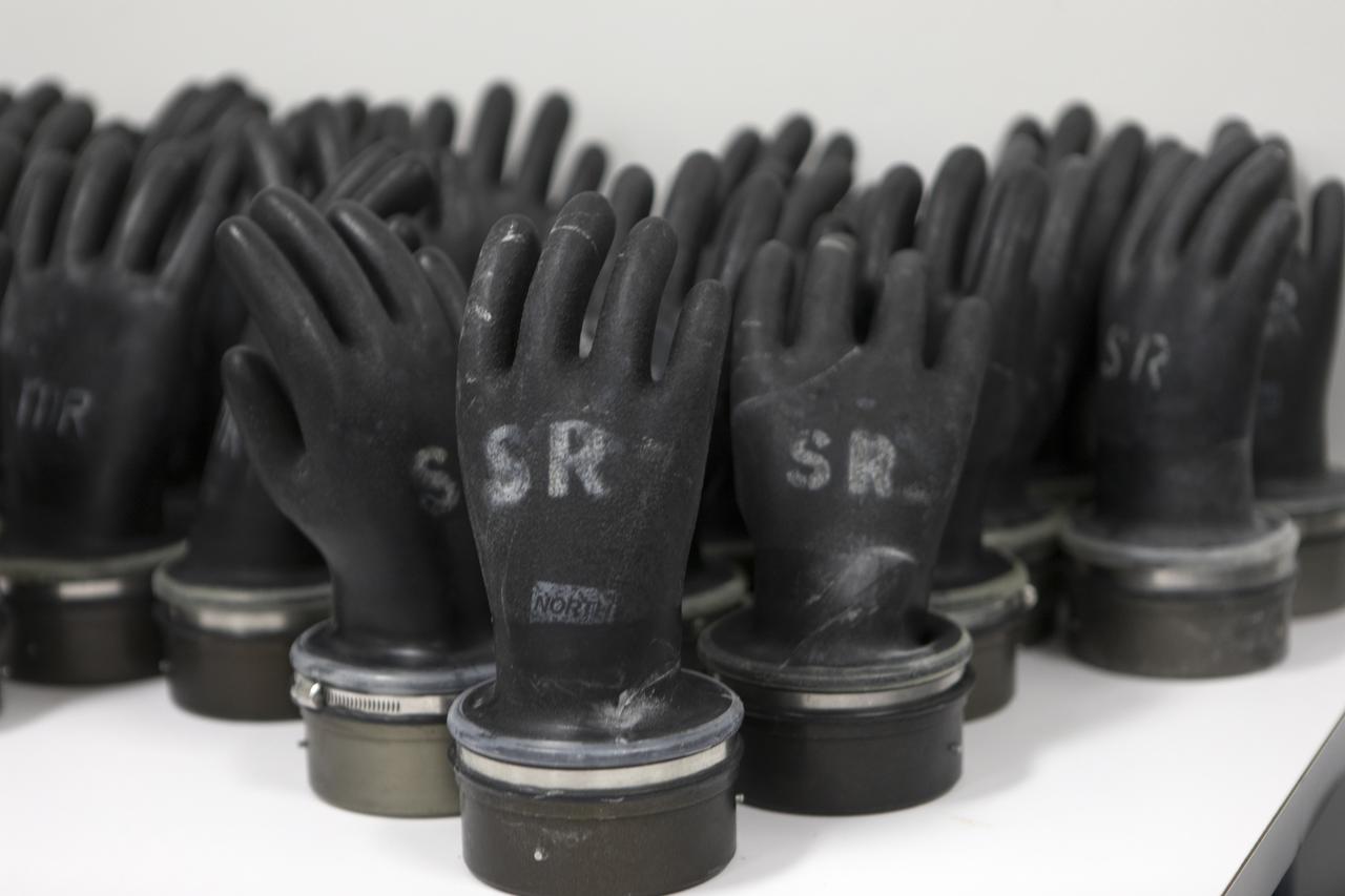 Technicans inside Kennedy's Multi-Payload Processing Facility do testing in SCAPE (Self-Contained Atmospheric Protective Ensemble) suits.