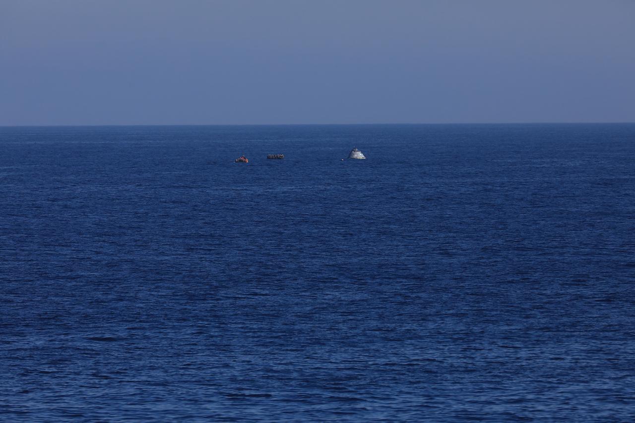 During Underway Recovery Test-7 (URT-7), U.S. Navy divers approach a test version of the Orion capsule to practice securing it for recovery into the well deck of an amphibious assault ship on Oct. 31, 2018 in the Pacific Ocean. The Exploration Ground Systems recovery team and the U.S. Navy work together to verify and validate procedures and hardware that will be used to recover the Orion spacecraft after it splashes down in the Pacific Ocean following deep space exploration missions. Orion will have emergency abort capability, sustain the crew during space travel and provide safe re-entry from deep space return velocities.