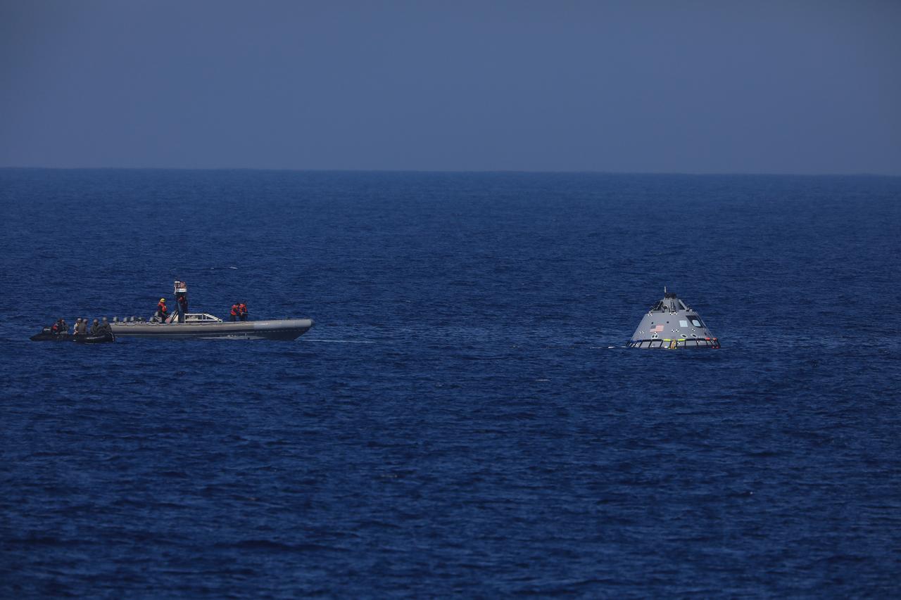 During Underway Recovery Test-7 (URT-7), U.S. Navy divers approach a test version of the Orion capsule to practice securing it for recovery into the well deck of an amphibious assault ship on Oct. 31, 2018 in the Pacific Ocean. The Exploration Ground Systems recovery team and the U.S. Navy work together to verify and validate procedures and hardware that will be used to recover the Orion spacecraft after it splashes down in the Pacific Ocean following deep space exploration missions. Orion will have emergency abort capability, sustain the crew during space travel and provide safe re-entry from deep space return velocities.
