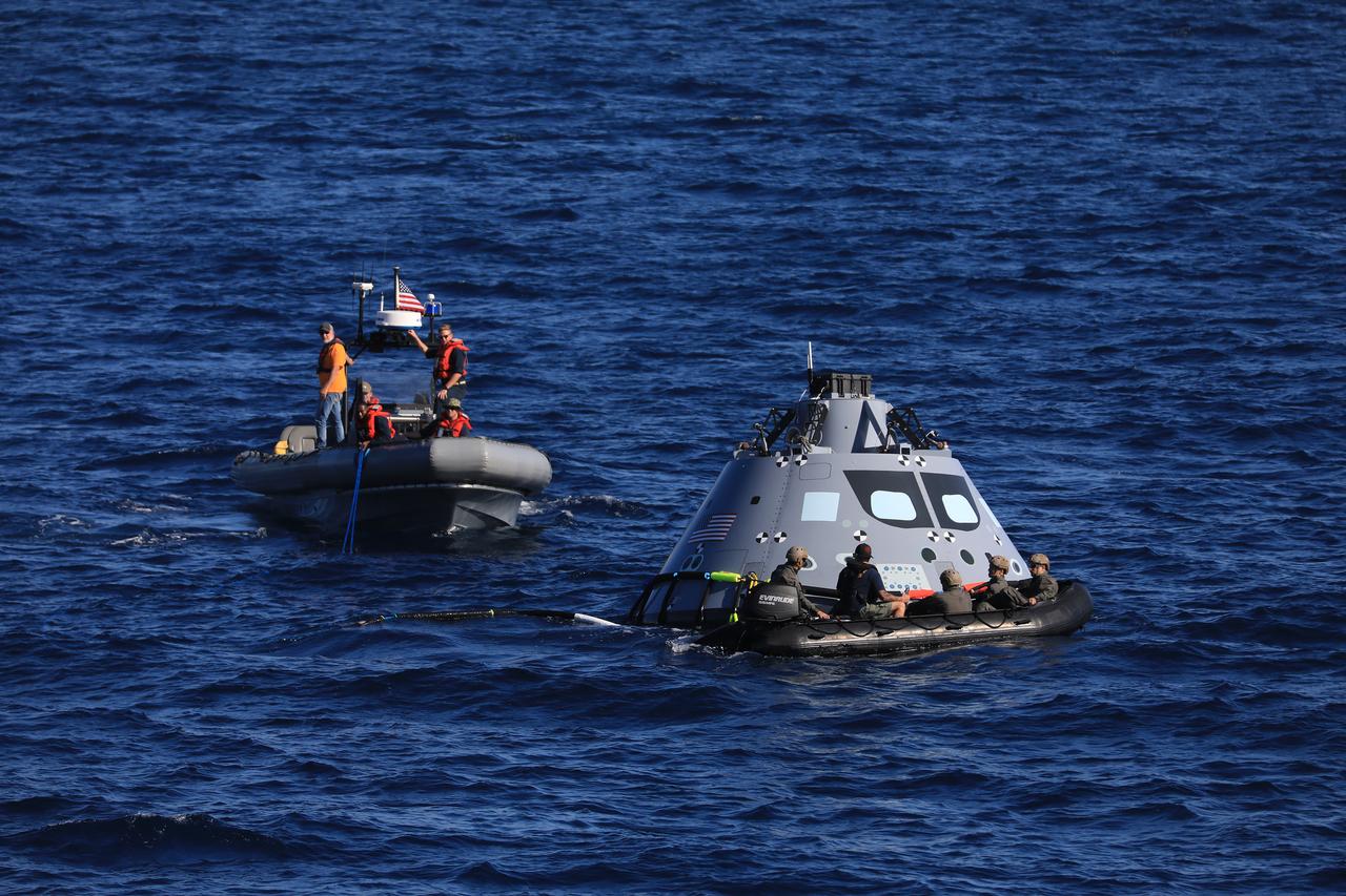 During Underway Recovery Test-7 (URT-7), U.S. Navy divers approach a test version of the Orion capsule to practice securing it for recovery into the well deck of an amphibious assault ship on Oct. 31, 2018 in the Pacific Ocean. The Exploration Ground Systems recovery team and the U.S. Navy work together to verify and validate procedures and hardware that will be used to recover the Orion spacecraft after it splashes down in the Pacific Ocean following deep space exploration missions. Orion will have emergency abort capability, sustain the crew during space travel and provide safe re-entry from deep space return velocities.