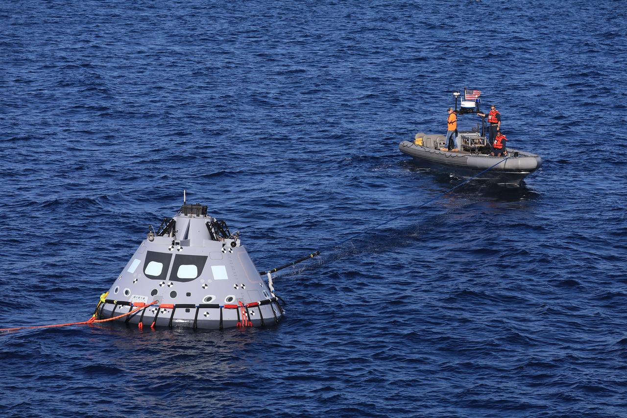 A U.S. Navy boat secures a tending line to a test version of the Orion capsule during Underway Recovery Test-7 (URT-7) on Oct. 31, 2018, in the Pacific Ocean. The Exploration Ground Systems recovery team and the U.S. Navy work together to verify and validate procedures and hardware that will be used to recover the Orion spacecraft after it splashes down in the Pacific Ocean following deep space exploration missions. Orion will have emergency abort capability, sustain the crew during space travel and provide safe re-entry from deep space return velocities.