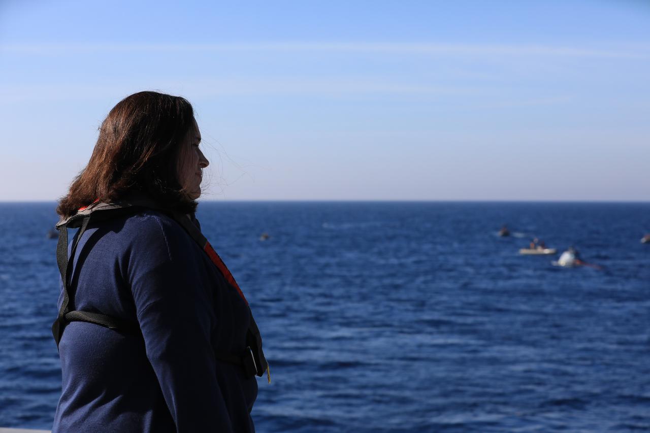 NASA's Landing and Recovery Director Melissa Jones observes recovery of a test version of the Orion capsule during Underway Recovery Test-7 (URT-7) on Oct. 31, 2018, onboard the ULL John P. Murtha, in the Pacific Ocean. URT-7 is one in a series of tests to verify and validate procedures and hardware that will be used to recover the Orion spacecraft after it splashes down in the Pacific Ocean following deep space exploration missions. Orion will have emergency abort capability, sustain the crew during space travel and provide safe re-entry from deep space return velocities.