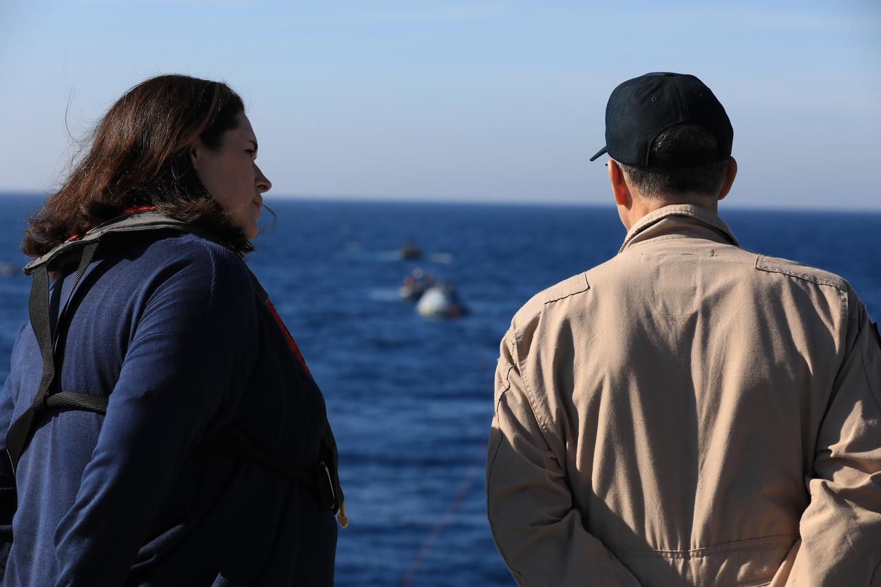 NASA's Landing and Recovery Director Melissa Jones and astronaut Don Pettit observe recovery of a test version of the Orion capsule during Underway Recovery Test-7 (URT-7) on Oct. 31, 2018, onboard the ULL John P. Murtha, in the Pacific Ocean. URT-7 is one in a series of tests to verify and validate procedures and hardware that will be used to recover the Orion spacecraft after it splashes down in the Pacific Ocean following deep space exploration missions. Orion will have emergency abort capability, sustain the crew during space travel and provide safe re-entry from deep space return velocities.