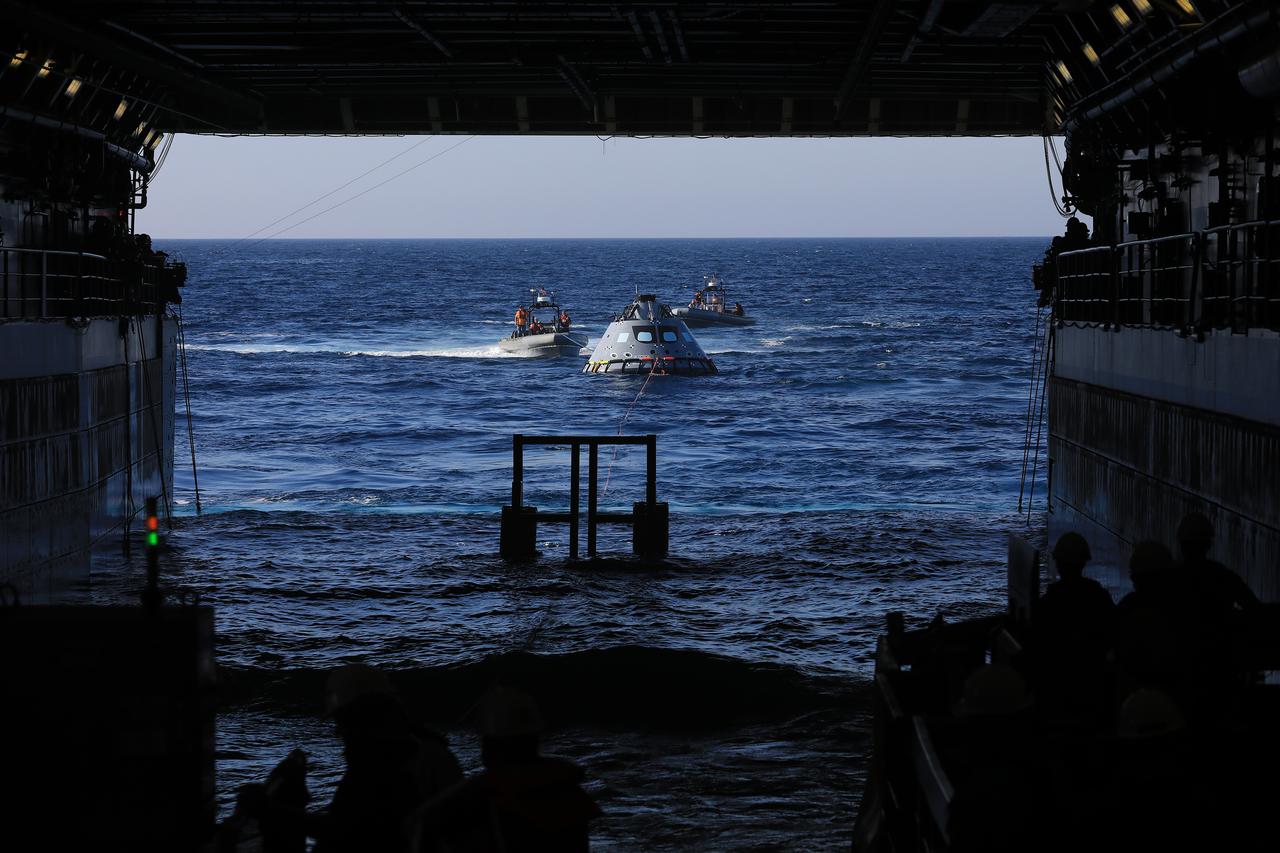 The Exploration Ground Systems recovery team, along with the U.S. Navy, practice recovering a test version of the Orion capsule and bringing it inside the well deck of the USS John P. Murtha during Underway Recovery Test-7 (URT-7) on Oct. 31, 2018, in the Pacific Ocean. URT-7 is one in a series of tests to verify and validate procedures and hardware that will be used to recover the Orion spacecraft after it splashes down in the Pacific Ocean following deep space exploration missions. Orion will have emergency abort capability, sustain the crew during space travel and provide safe re-entry from deep space return velocities.